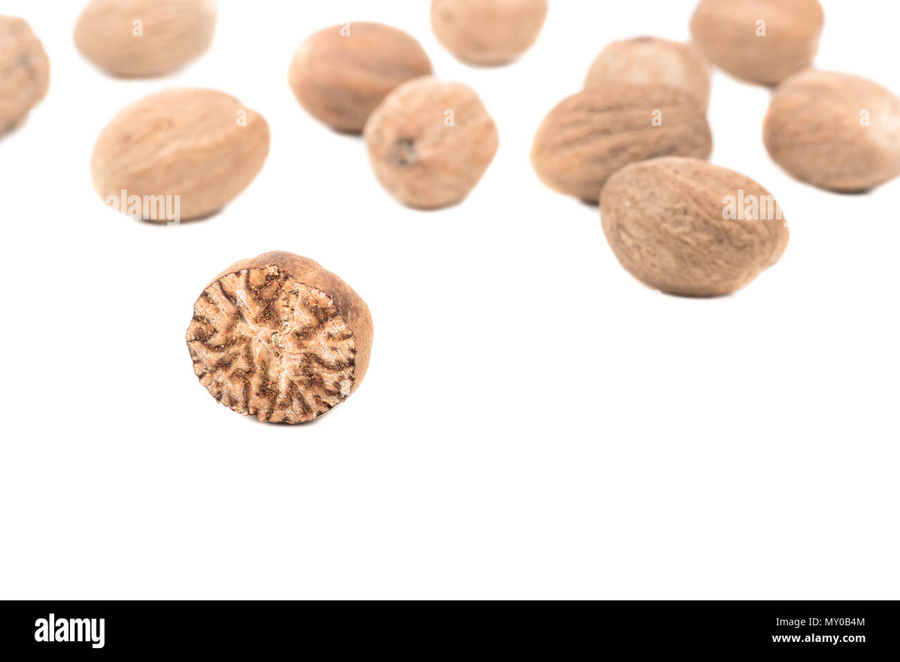 Half nutmeg with scatter nuts on a white background Stock Photo Alamy