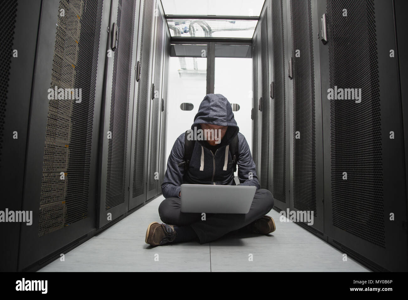 Focused male hacker cracking software Stock Photo