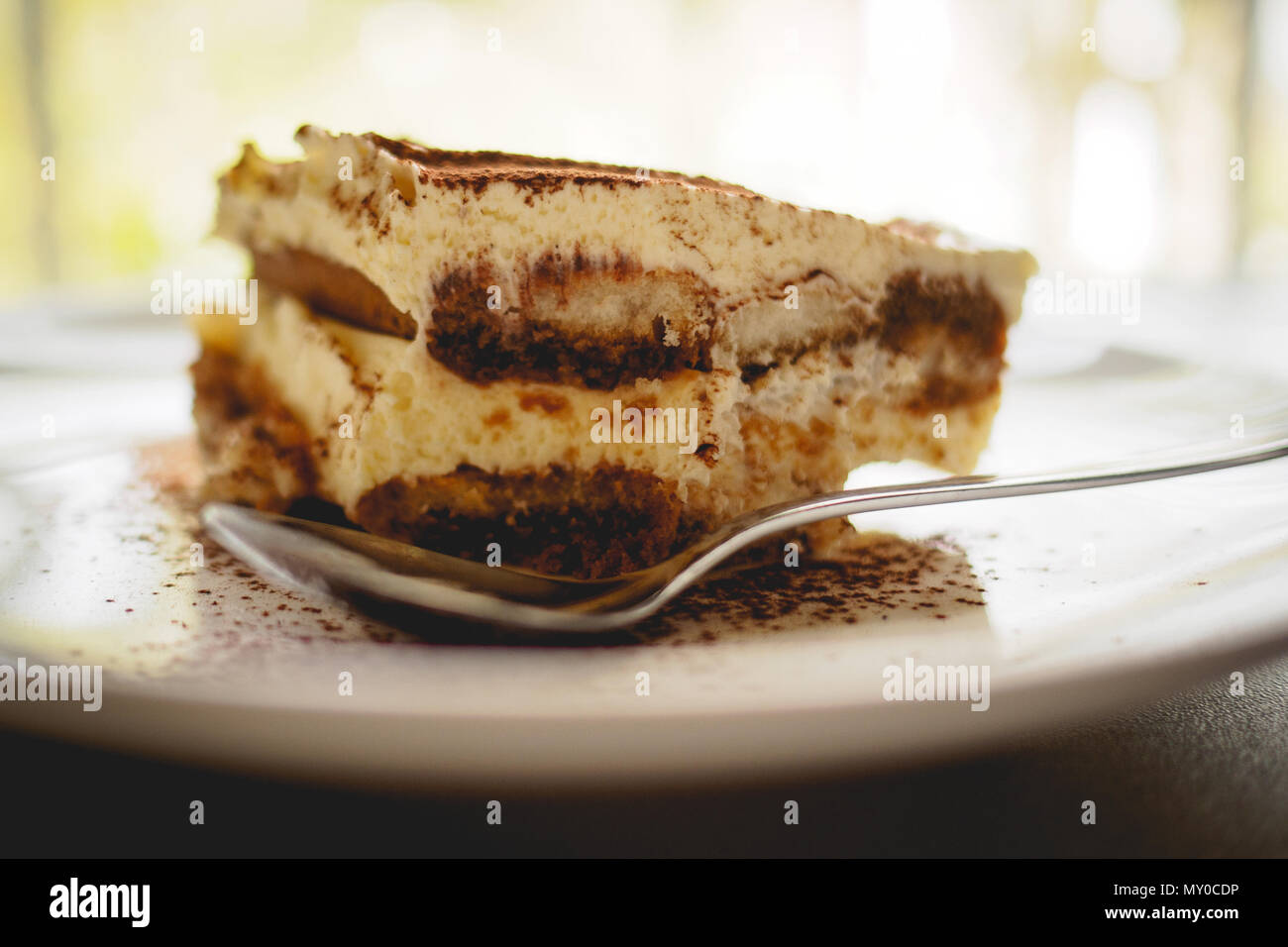 Close Up Of A Slice Of Homemade Tiramisu Traditional Italian Dessert On A White Plate With A Spoon On A Marble Board Landscape Format Stock Photo Alamy