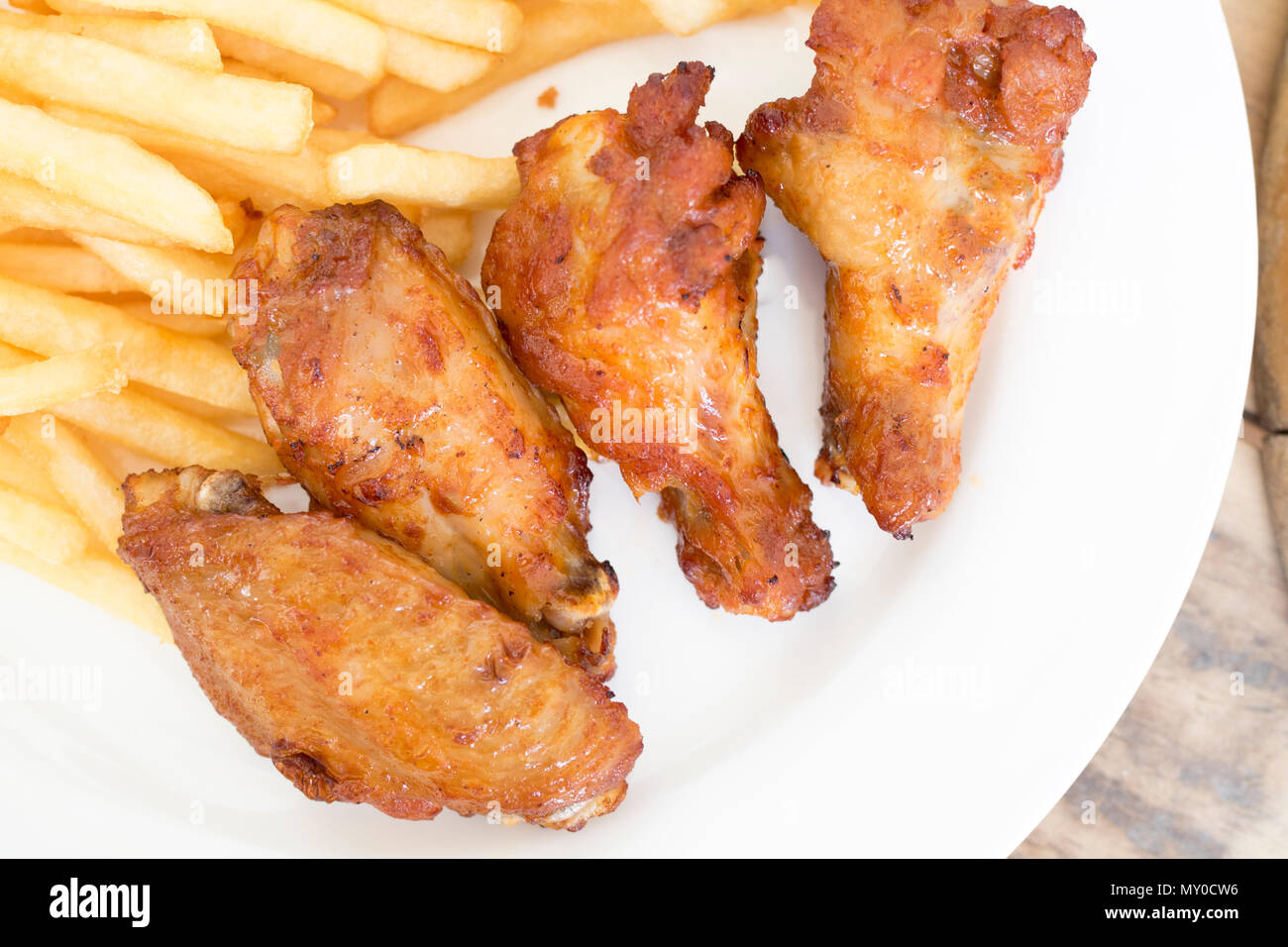 Fast food, crispy chicken wings and french fries on wood background Stock Photo Alamy