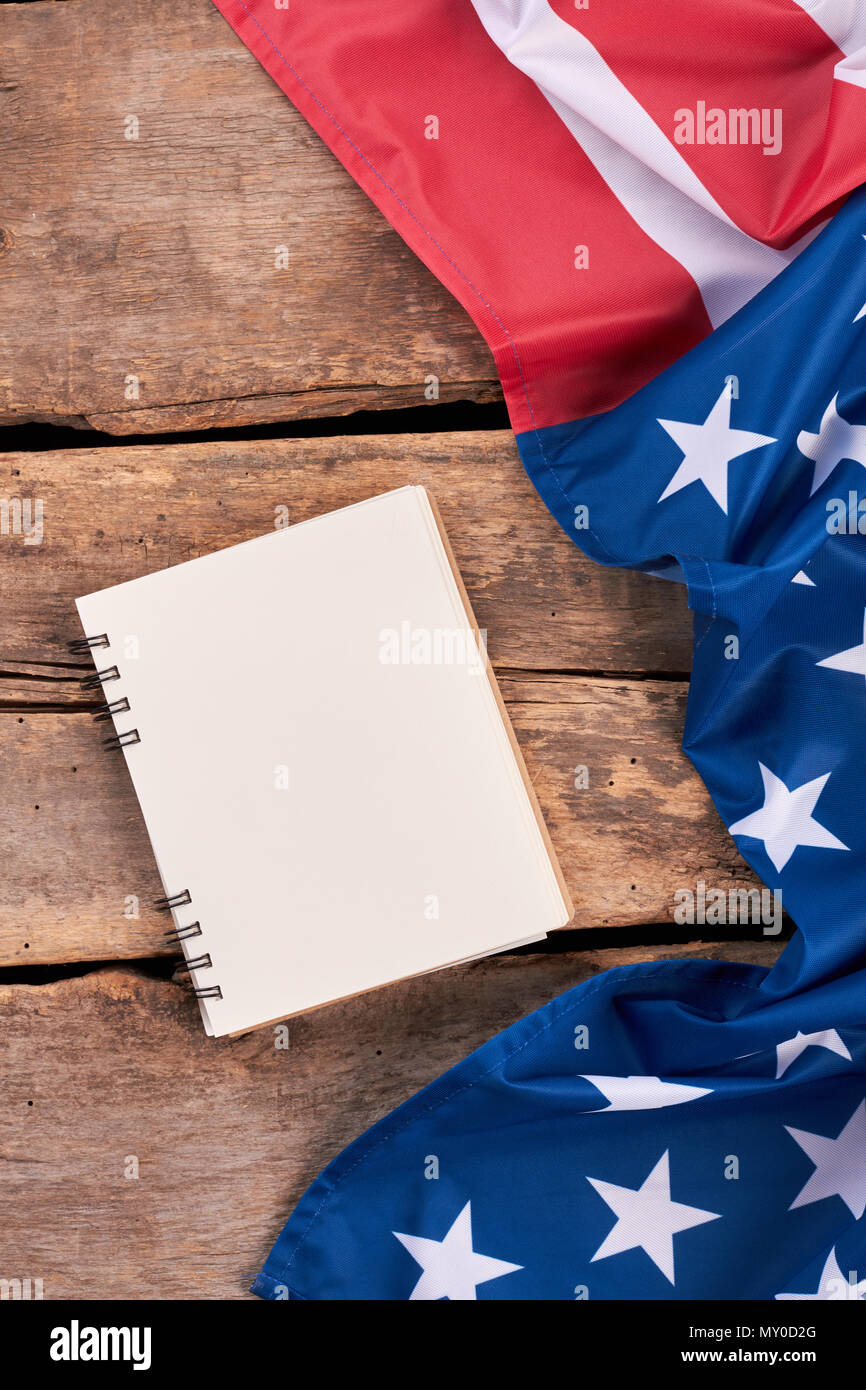 Flagging Notebook USA flag and notepad, vertical image. Crumpled flag of America and ...