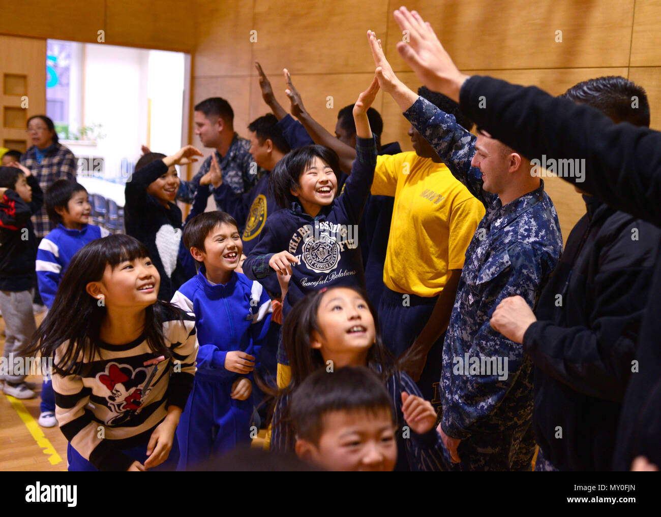161219-N-OK605-167 MISAWA, Japan (Dec. 19, 2016) Sailors from Naval Air Facility Misawa (NAFM) interact with the children at the Ohzora Jido-Kan, a Japanese after school care center, for a special holiday themed visit. Sailors from NAFM volunteer to make bi-weekly visits to the after school care center as part of community relations efforts. (U.S. Navy Photo by Petty Officer 2nd Class Samuel Weldin/Released) Stock Photo