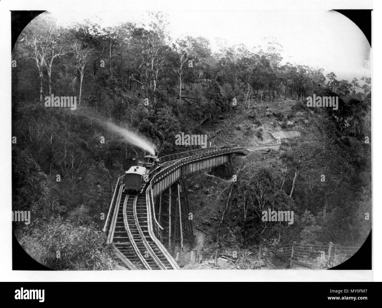 Train bridge on Main Range, Toowoomba, c 1870. Toowoomba Chronicle 14 July 1877  RAILWAY EXTENSION. 217690622 )   A deputation from Highfields was to have waited on tho Minister for Works to-day relative to the extension of the railway from the summit of tho Main Range to Crow's Nest. As some of the members of the deputation did not arrive in time, the interview ans postponed until eloven o'clock on Monday next. Stock Photo