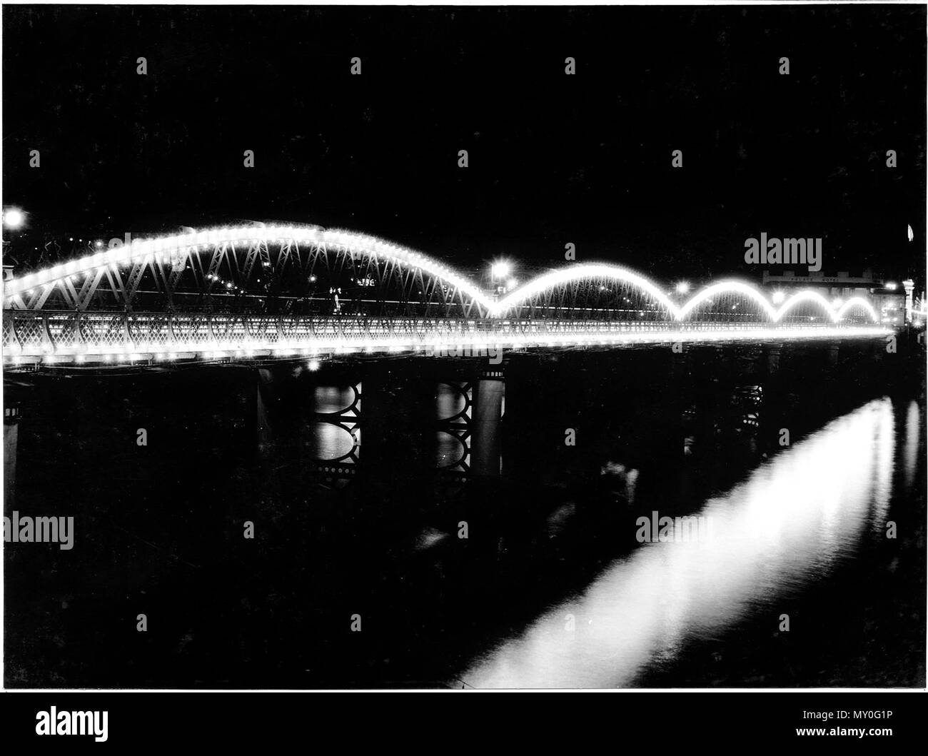 Victoria Bridge illuminations - Royal Visit, Brisbane, March 1954. The Courier-Mail 23 February 1954  BRIDGES LIT UP TO-NIGHT  ROYAL TOUR illuminations on Victoria Bridge and Story Bridge will be switched on to-night.  The Premier (Mr. Gair) said yesterday that this would be the first of a series of such trials.  Others would be: — To-morrow night: South Brisbane Memorial Park, South Brisbane Town Hall, Centenary Place and Albert, Alice and Wickham Streets.  Thursday night: Grey Street Bridge, Coronation Drive and Davies Park. Friday night: The City Hall and other city illuminations, Including Stock Photo