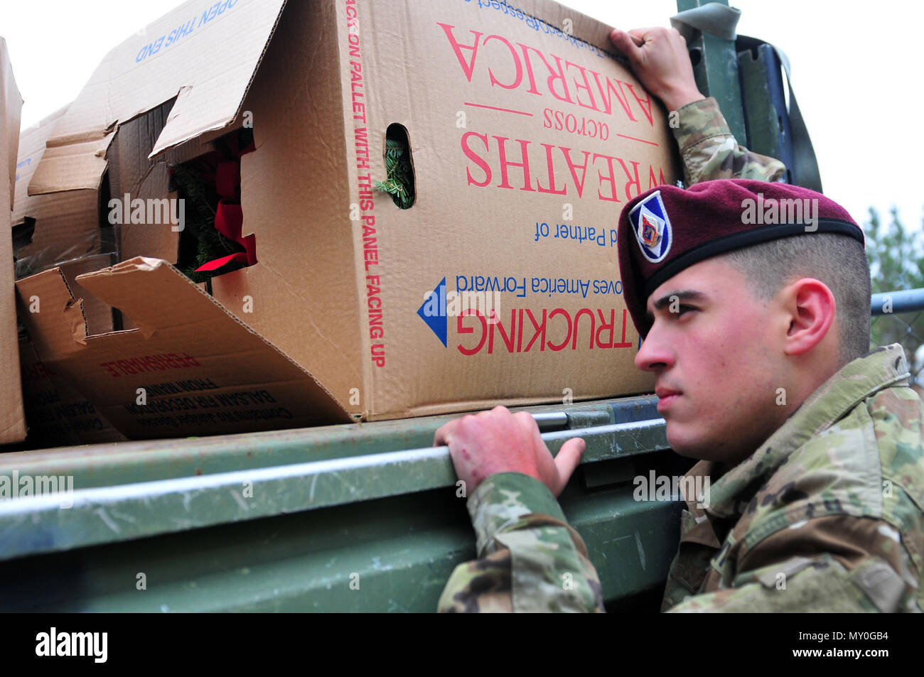 Pfc. Christopher Longoria, a Soldier assigned to XVIII Airborne Corps’ Headquarters and Headquarters Battalion, loads boxes of holiday wreaths onto the back of a military cargo truck, near Spring Lake, N.C. Dec. 17, 2016.  The wreaths were delivered to the Sand Hills State Veteran’s Cemetery nearby as part of an event called Wreaths Across America.  According to Senate Resolution 726 of the 110th U.S. Congress, the annual event “recognizes the sacrifices our veterans, service members and their families have made, and continue to make, for our great Nation.” (U.S. Army photo by Pfc. Hubert D. D Stock Photo