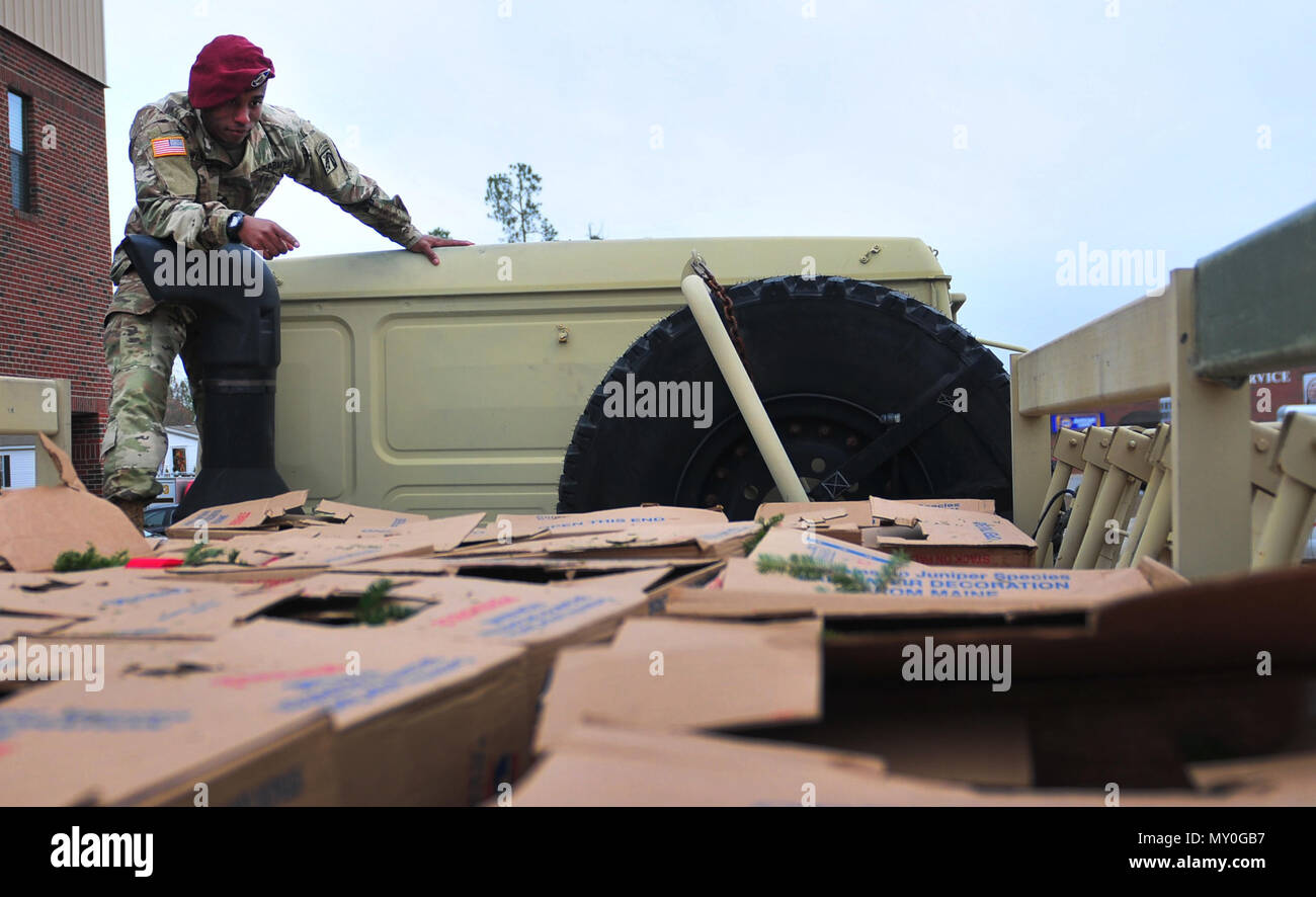 Pfc. Samuel Williams, a XVIII Airborne Corps Soldier, counts stacked boxes of holiday wreaths on the back of a military cargo truck near Spring Lake, N.C. Dec. 17, 2016.  The wreaths were delivered to the Sand Hills State Veteran’s Cemetery nearby as part of an event called Wreaths Across America.  According to Senate Resolution 726 of the 110th U.S. Congress, the annual event “recognizes the sacrifices our veterans, service members and their families have made, and continue to make, for our great Nation.” (U.S. Army photo by Pfc. Hubert D. Delany III/22nd Mobile Public Affairs Detachment) Stock Photo