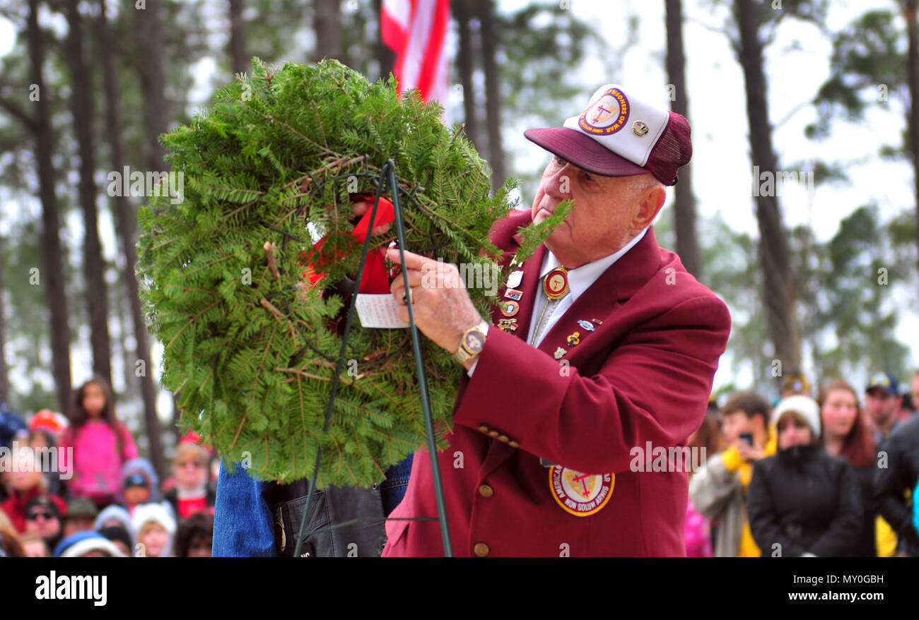 Retired Sgt. Maj. Jacob Roth, formally of the 5th Special Forces Group (Airborne), hangs a holiday wreath representing the service of fallen prisoners of war during a Wreaths Across America event at the Sand Hills State Veteran’s Cemetery in Spring Lake, N.C. Dec. 17, 2016. According to Senate Resolution 726 of the 110th U.S. Congress, “recognizes the sacrifices our veterans, service members and their families have made, and continue to make, for our great Nation.” (U.S. Army photo by Pfc. Hubert D. Delany III/22nd Mobile Public Affairs Detachment) Stock Photo