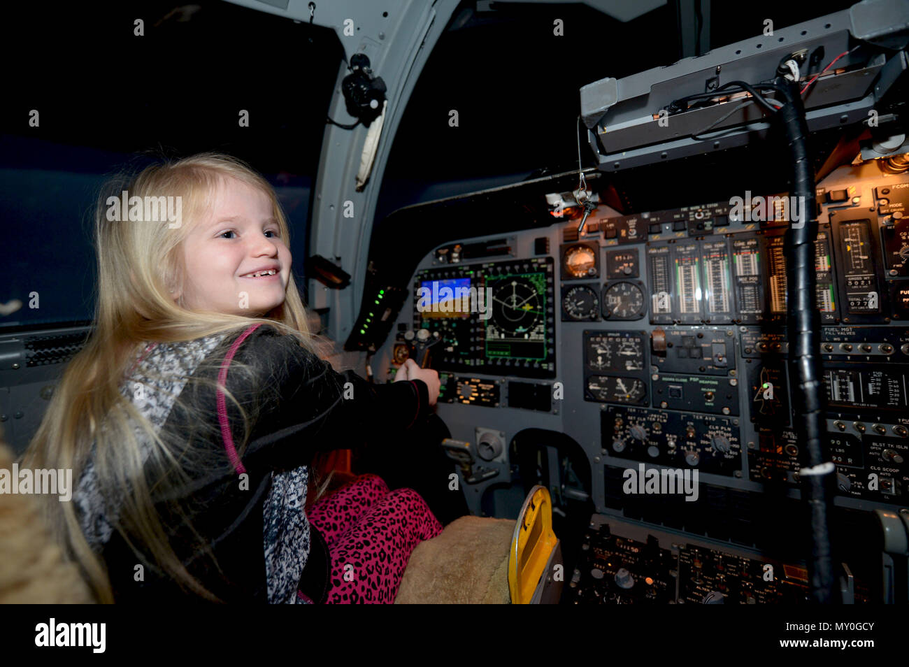 Zaida Knight, daughter of retired Tech. Sgt. Michael Knight and his wife, Traci Knight, flies a B-1 bomber simulator at Ellsworth Air Force Base, S.D., Dec. 20, 2016. The simulator consists of two sections, one for flying the plane itself and one for bombing. Stock Photo