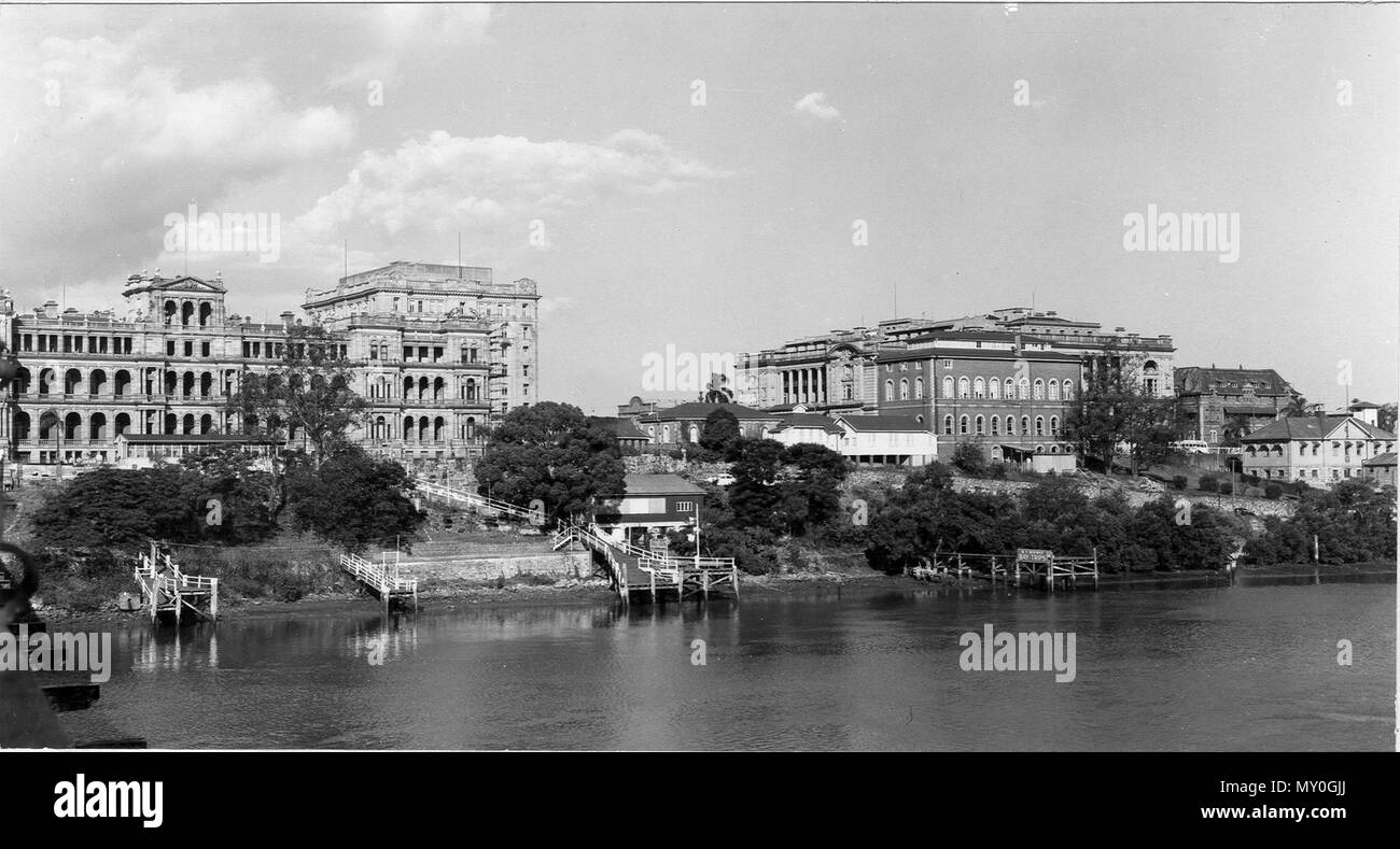 Brisbane city from Victoria Bridge, December 1957. The Courier-Mail 5 January 1951  Unsightly river 50103135 )   Lack of beautification of the Brisbane River was deplored yesterday by the Acting Premier (Mr. Gair).  He was speaking at a civic reception to the Port of London Authority chairman (Sir John Anderson).  When we look outside our offices in the Treasury Building, we look on unsightly and unattractive foreshores, Mr Gair said. The river banks are most unattractive, particularly on the southside but also on the north side. Stock Photo