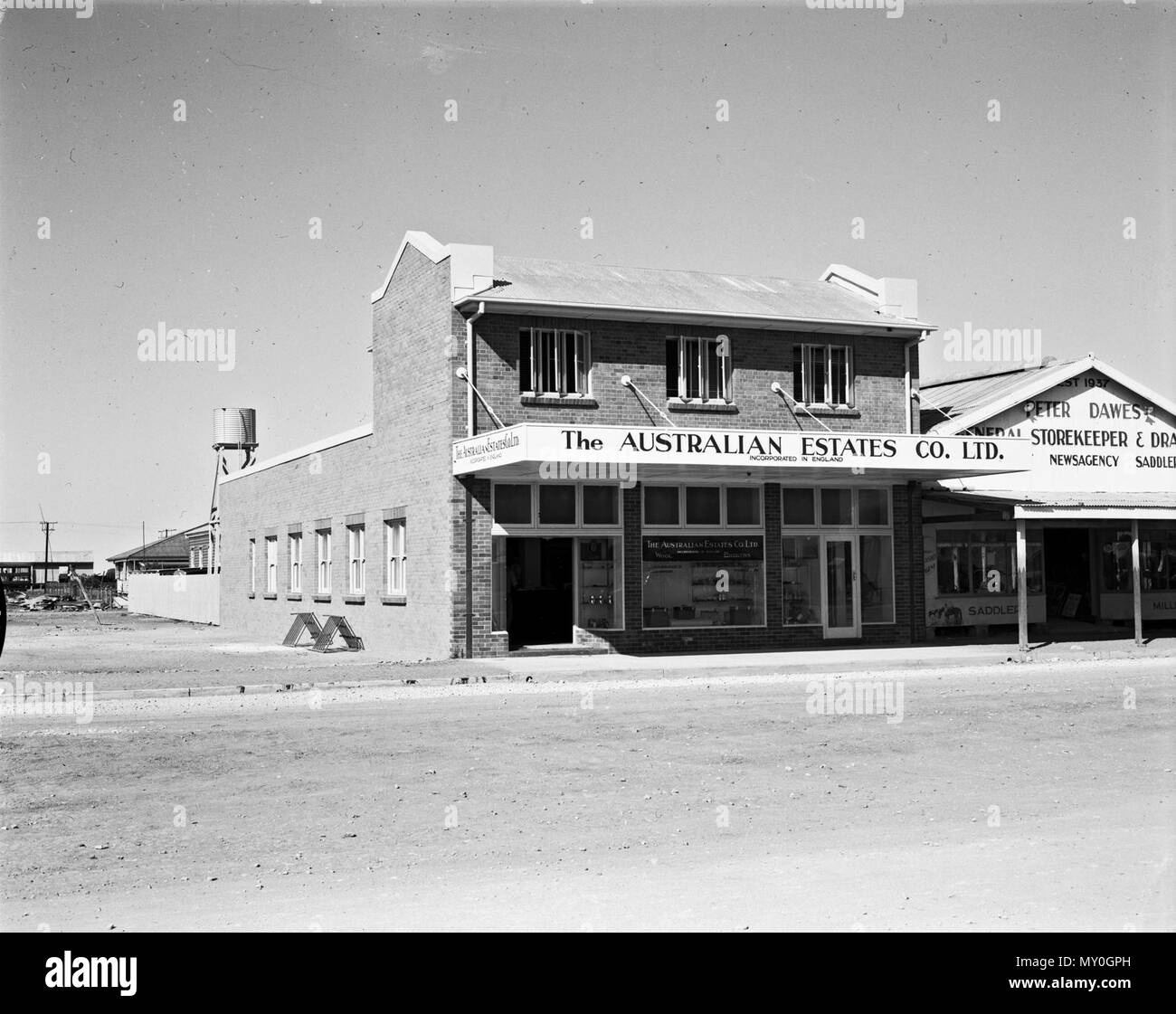 Burke Street, Julia Creek, c 1953. The Australian Estates &amp; Mortgage Co Ltd was founded in 1894 as wool and produce selling brokers, stock and station agents, pastoralists, raw sugar millers and cane growers. It renamed The Australian Estates Company Limited in 1936 and was taken over by CSR Limited in 1975.  As of August 2017, both these building still exist. Stock Photo
