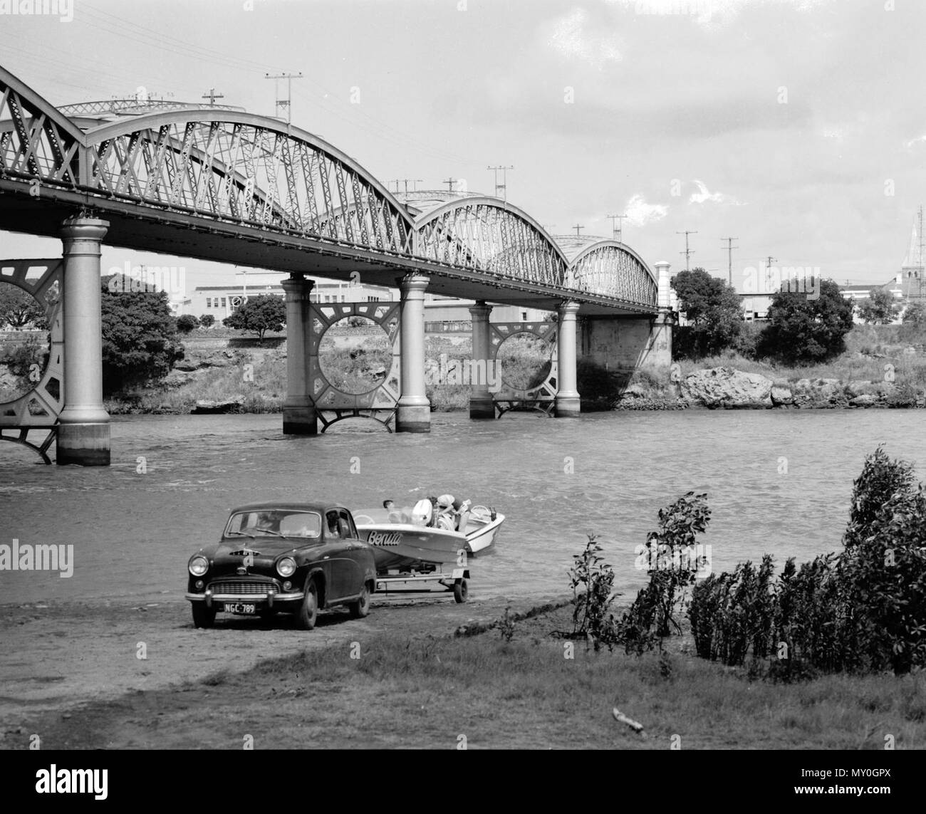 Burnett Bridge, Bundaberg, 1963. From the Queensland Heritage Registerid=600368 ) .  The Burnett Bridge is a metal truss bridge spanning the Burnett River at Bundaberg, linking the two sections of the city. It was constructed in 1900 to the design of A.B. Brady.  The Burnett area was first settled by Europeans in the 1840s and 50s as a series of pastoral runs. In the late 1860s, as good agricultural land around Maryborough began to be scarce, agriculturalists and timbergetters became interested in land on the navigable Burnett River to the north. The foundation settlers of Bundaberg selected l Stock Photo