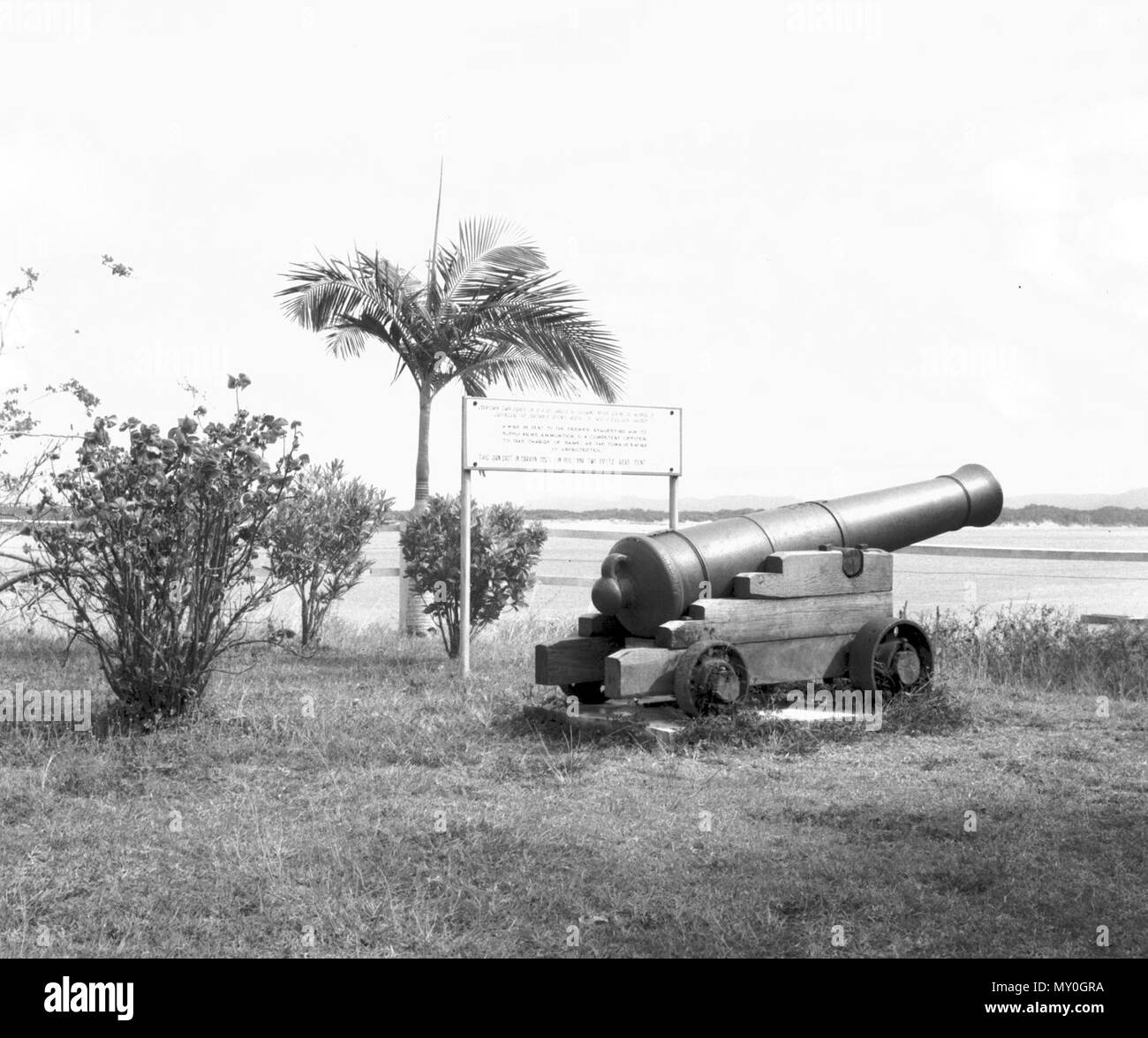 Cannon, Cooktown, c 1966. Cooktown Town Council on 10-4-1885 carried the following motion asking the Premier of Queensland that Cooktown be defended against the threat of a Russian invasion:  A WIRE BE SENT TO THE PREMIER REQUESTING HIM TO SUPPLY ARMS, AMMUNITION &amp; A COMPETENT OFFICER TO TAKE CHARGE OF SAME, AS THE TOWN IS ENTIRELY UNPROTECTED.  This gun cast in Carron, Scotland in 1803 and two rifles were sent. Stock Photo