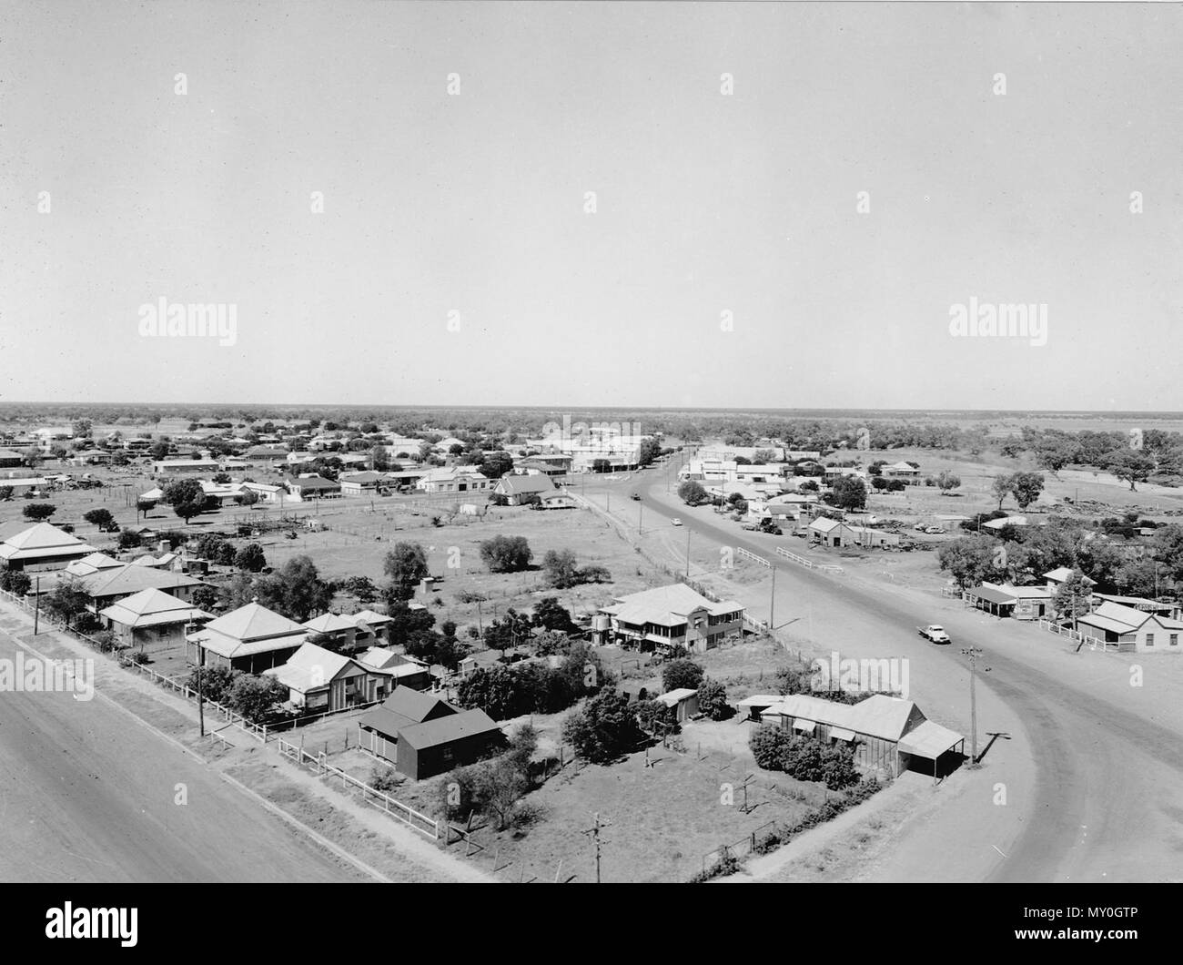 Aerial view of Cunnamulla, January 1955. Cunnamulla means long stretch of water and the town was founded at the intersection of two major stock routes which needed a reliable water supply. It became a coach stop for Cobb and Co coaches and the town was formally surveyed in 1868. Stock Photo