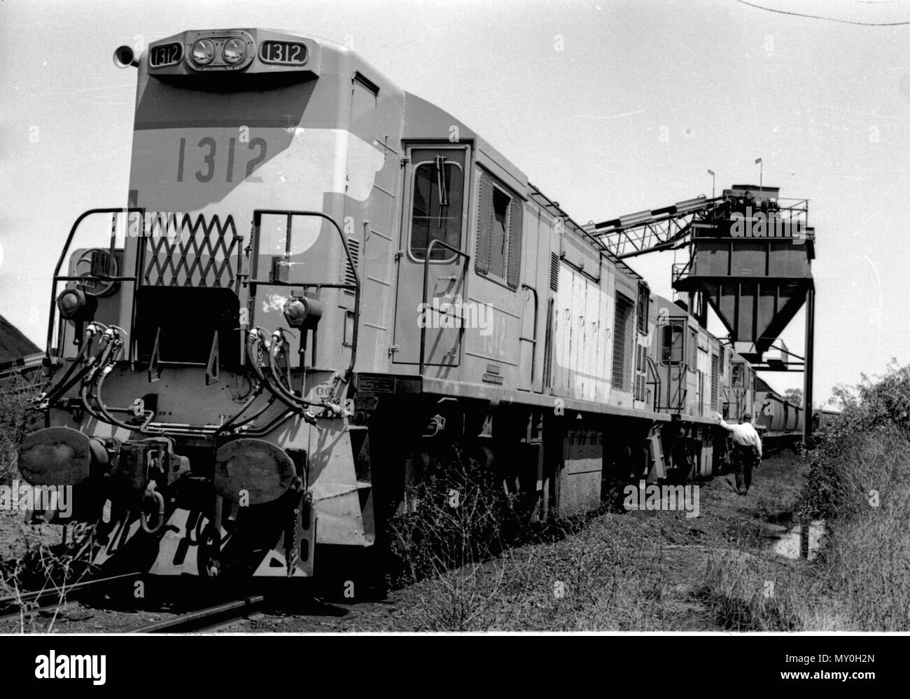Coal train, Kinrola Mine, Blackwater, c 1971. have identified the location as Kinrola.  The 1300 class diesel locomotives were built by English Electric at Rocklea, Brisbane between 1967 and 1972 for use on the Blackwater and Moura coal lines and based at Gladstone. They were sold to the Australian National Railways in 1988 and shipped to Tasmania. Stock Photo