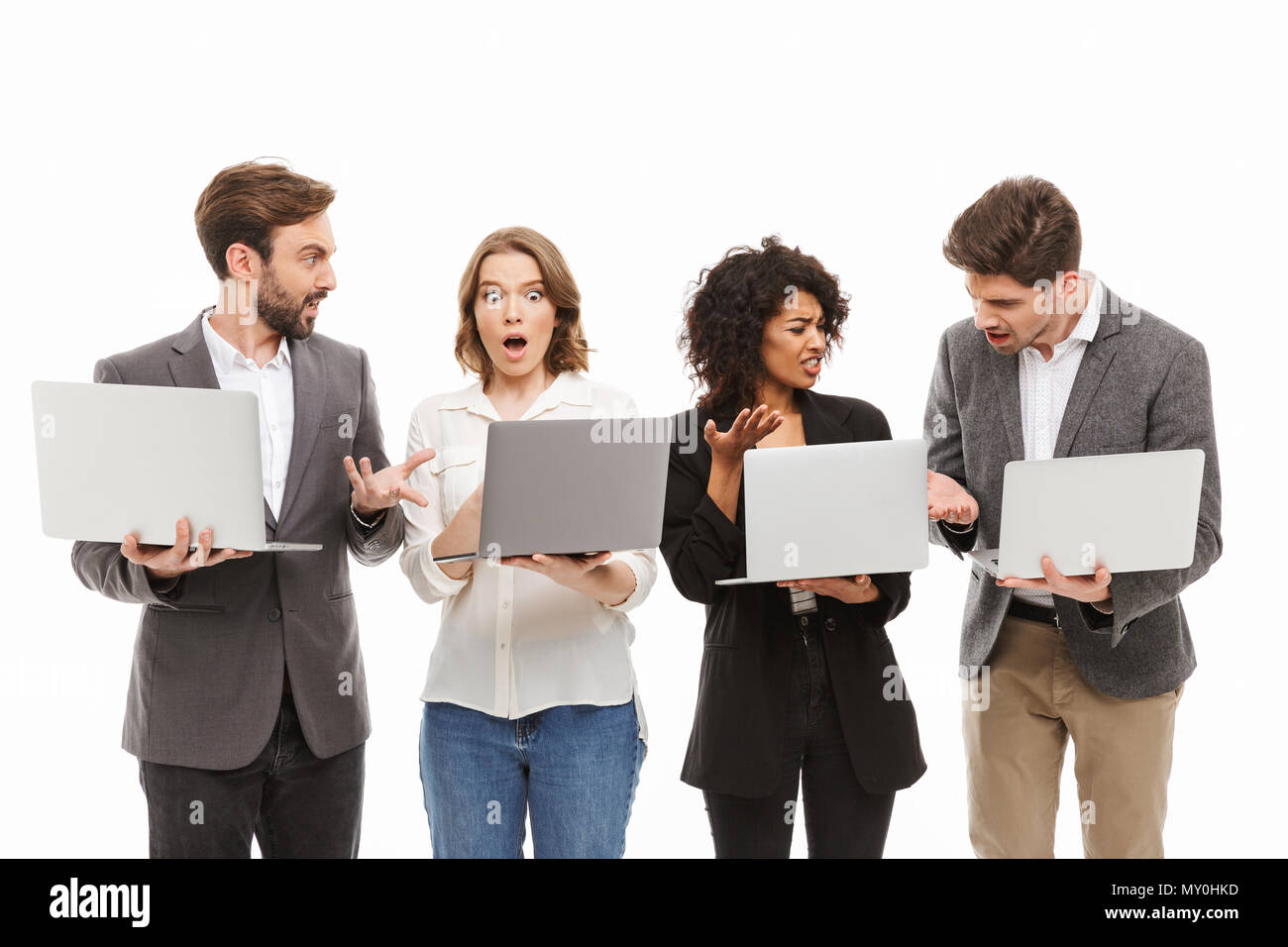Portrait of a group of confused multiracial business people holding laptop  computers isolated over white background Stock Photo - Alamy