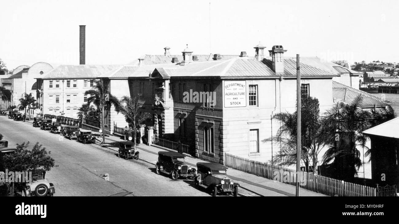 Former Department of Primary Industries Building, William Street, Brisbane, June. From the Queensland Heritage Registerid=601093 ) .  The former Department of Primary Industries building, finished in unpainted render and painted brickwork, is built on a steeply sloping site with two storeys and basement fronting William Street and a lower three-storeyed wing at the rear fronting Queen's Wharf Road. with a hipped rib and pan galvanised iron roof.  The building was originally built as an Immigration Depot, and construction began in 1865 and completed in 1866.  The building was constructed on par Stock Photo
