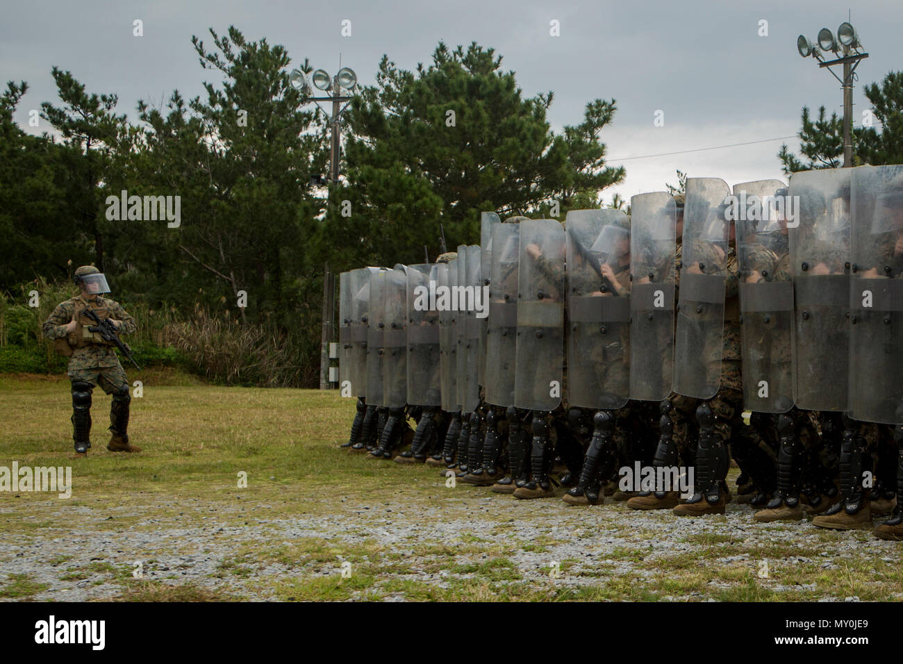 Marines with Echo Battery, Battalion Landing Team, 2nd Battalion, 5th Marines, 31st Marine Expeditionary Unit and military police with Combat Logistics Battalion 31, 31st MEU, conduct non-lethal weapons training at Camp Hansen, Okinawa, Japan, Dec. 29, 2016. Echo Battery and Military Police Platoon trained with modified weapons to reinforce crowd and riot control tactics using non-lethal munitions. As the Marine Corps' only continuously forward-deployed unit, the 31st MEU air-ground-logistics team provides a flexible force, ready to perform a wide range of military operations, from limited com Stock Photo