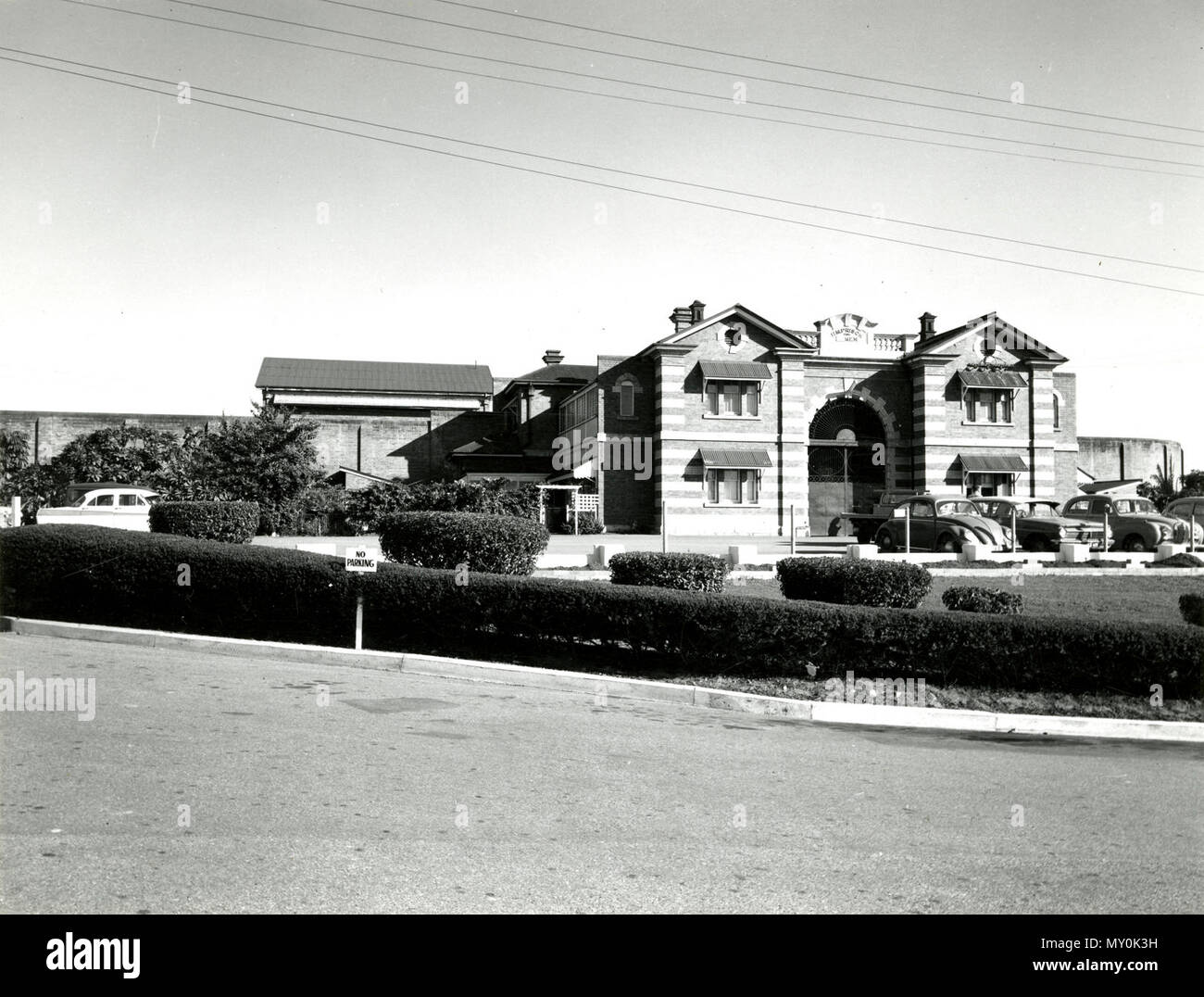 HM Prison Boggo Road, August 1965. From the Queensland Heritage Registerid=601033 ) .  Boggo Road Gaol No 2 Division was opened in 1903 as the State Prison for Women at Boggo Road South Brisbane.  It was built adjacent to a male prison, which was established on the site in 1883. The male prison was later to become No 1 Division. The female prison was constructed in response to a 1887 Parliamentary Inquiry, which recommended that the separate system be introduced, that is a separate cell for each prisoner. The Inquiry also recommended that a female section be established within the Brisbane Gao Stock Photo
