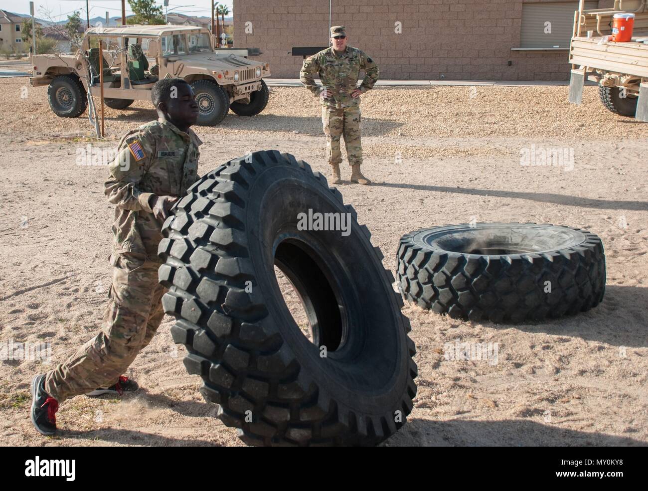 FORT IRWIN, Calif. — U.S. Army Staff Sgt. Schandorf Asabere, E Troop, 2nd Squadron, 11th Armored Cavalry Regiment, flips a tire during the physical fitness portion of the NCO of the Quarter competition.  Schandorf earned the honor of being named Fort Irwin‘s NCO of the Quarter, 1st quarter, 2017.  The NCO of the Quarter board is a daylong event designed to evaluate the NCO’s, both physically and mentally. (U.S. Army photo by Sgt. David Edge) Stock Photo