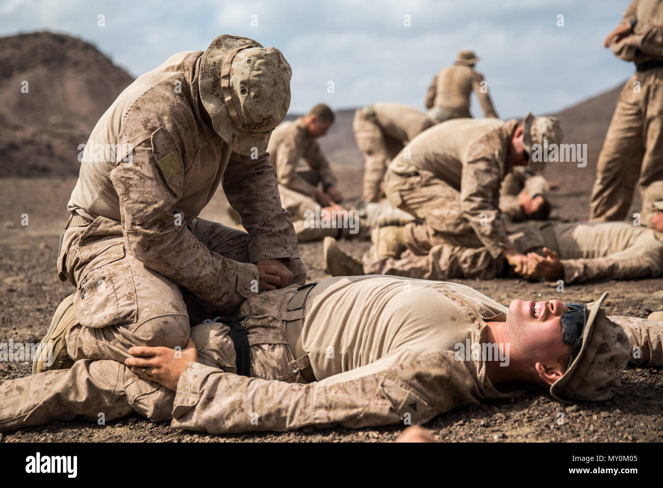 DJIBOUTI (Dec. 14, 2016) U.S. Marines with Battalion Landing Team 1st Bn., 4th Marines, 11th Marine Expeditionary Unit (MEU), apply tourniquets during tactical casualty combat care (TCCC) training as part of Exercise Alligator Dagger, Dec. 14. As the second phase of TCCC, Marines must ensure a patient displaying the signs and symptoms of a massive hemorrhage is treated with tourniquets or pressure dressing at the point of injury to stop the bleeding before the patient is passed to MEU medical assets. The unilateral exercise provides an opportunity for the Makin Island Amphibious Ready Group an Stock Photo