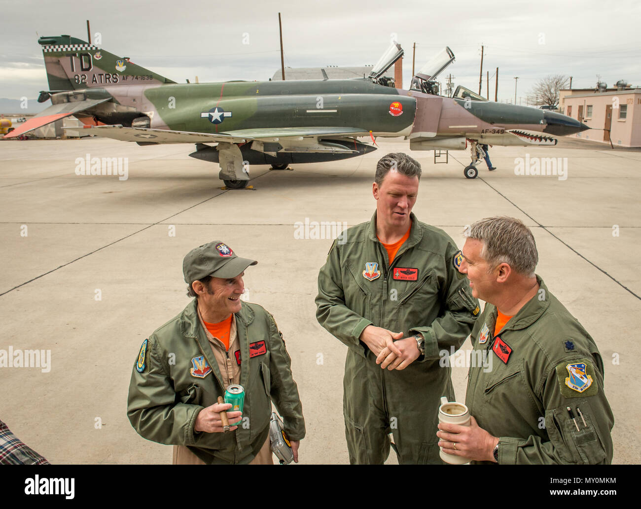The last active-duty Air Force pilot to fly the McDonnell Douglas F-4 Phantom II, Lt. Col. Ron 'Elvis' King, right, commander of the 82nd Aerial Target Squadron Detachment 1 talks with former QF-4 pilot Eric 'Rock' Vold and Civilian QF-4E Pilot/Controller Lt. Col. (Ret) Jim “WAM” Harkins, after they piloted the final military flight of the storied aircraft at Holloman AFB, N.M., Dec. 21, 2016. The F-4 Phantom II entered the U.S. Air Force inventory in 1963 and was the primary multi-role aircraft in the USAF throughout the 1960s and 1970s. The F-4 flew bombing, combat air patrol, fighter escort Stock Photo