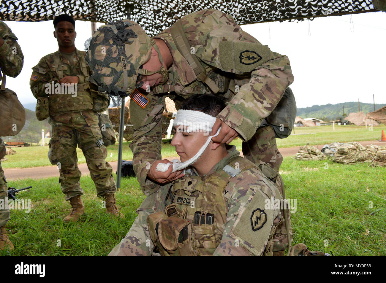 Spc. Connor Bassett (standing) practices how to perform first aid for