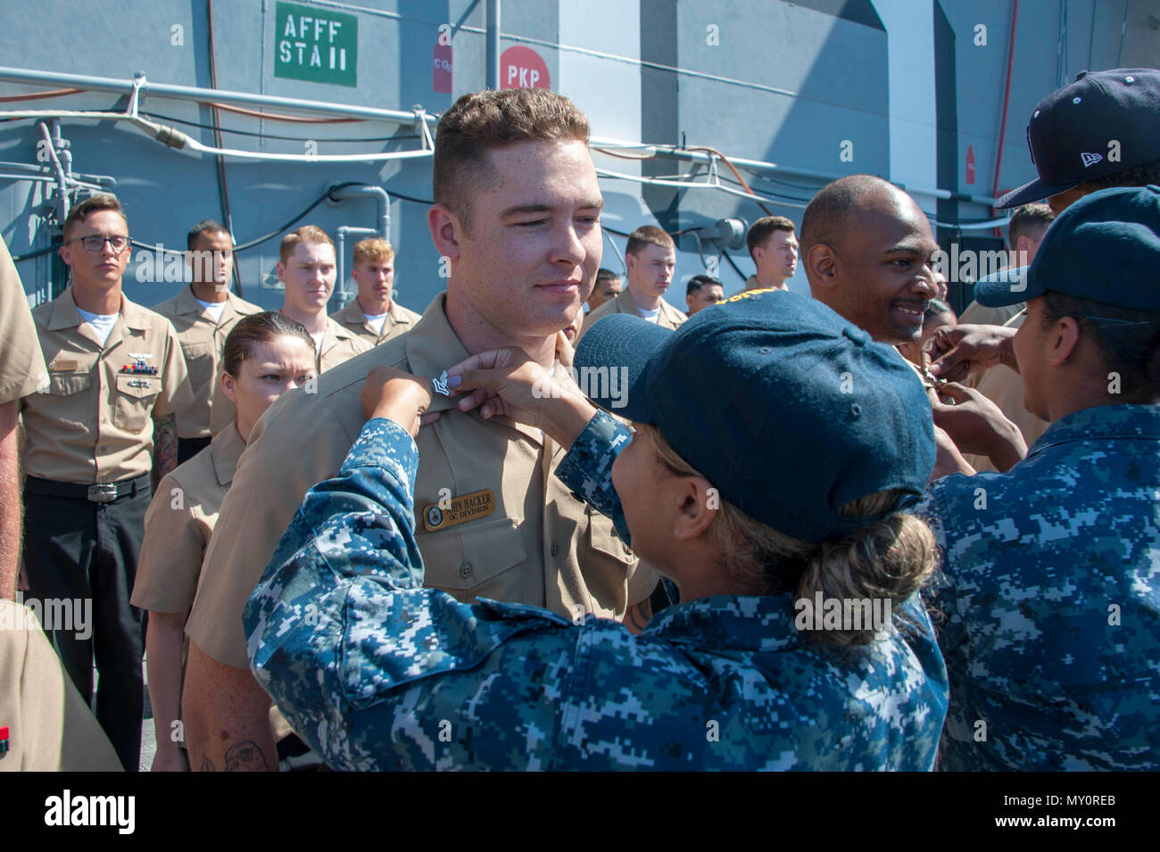 180601-N-ZS023-036 NAVAL BASE SAN DIEGO (June 1, 2018) A Sailor aboard the amphibious assault ship USS America (LAH 6) is frocked during a ceremony on the flight deck. America is moored at its homeport of Naval Base San Diego and is conducting a planned maintenance availability in preparation for the ship’s next tour of duty. (U.S. Navy photo by Mass Communication Specialist 3rd Class Vance Hand/Released) Stock Photo