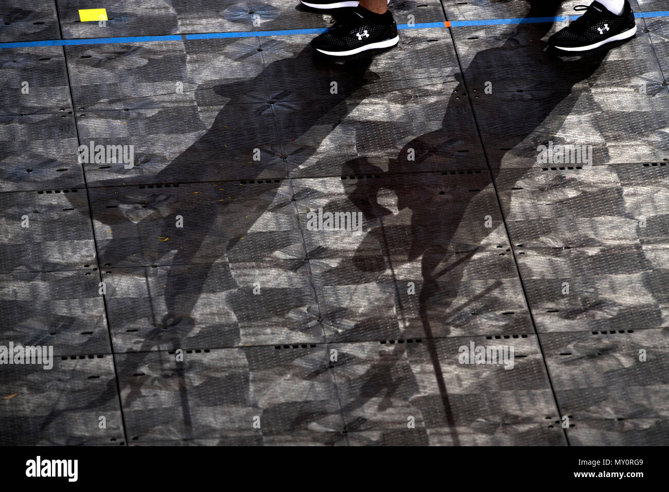 Shadows from a pair of archers decorate a floor during practice for the 2018 Warrior Games at the Air Force Academy in Colorado Springs, Colo. June 1, 2018. (DoD photo by EJ Hersom) Stock Photo