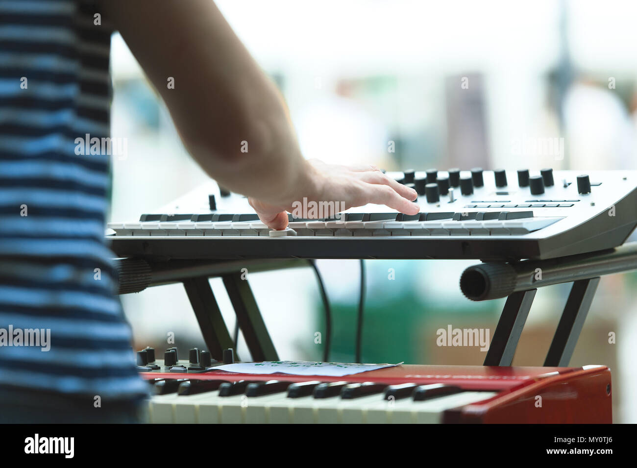 Keyboard player of a pop group during a show. Stock Photo