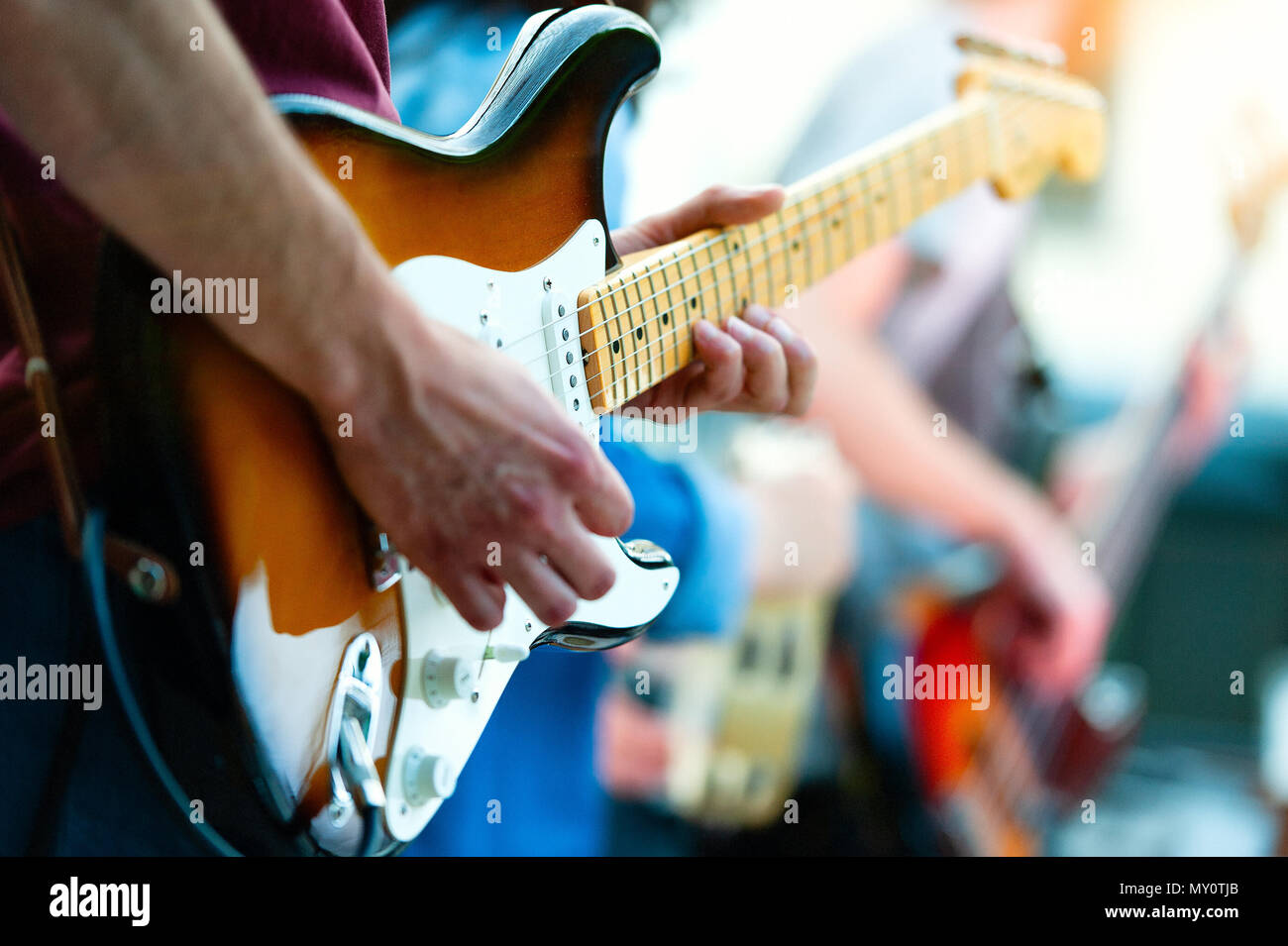 Detail of guitarist of a pop group during a show. Stock Photo