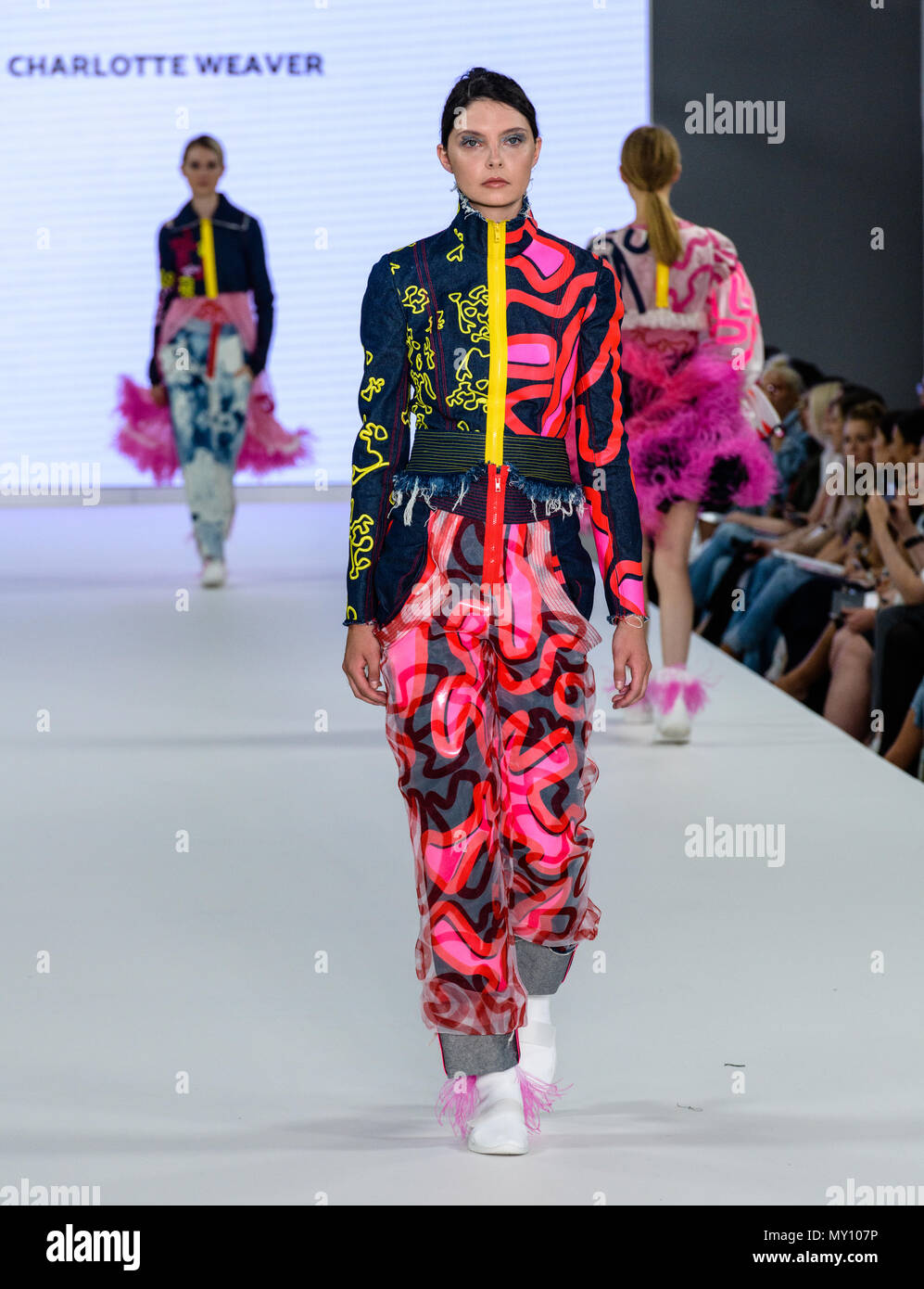 London, UK. 4th June, 2018. Charlotte Weaver's Collection of bleached coral inspired denim wash print designs and body con hooded caps with feather like sea worms seen during Bath Spa's Fashion Show at Graduate Fashion Week in London 2018. Credit: Marc Wainwright Photography/Alamy Live News Stock Photo