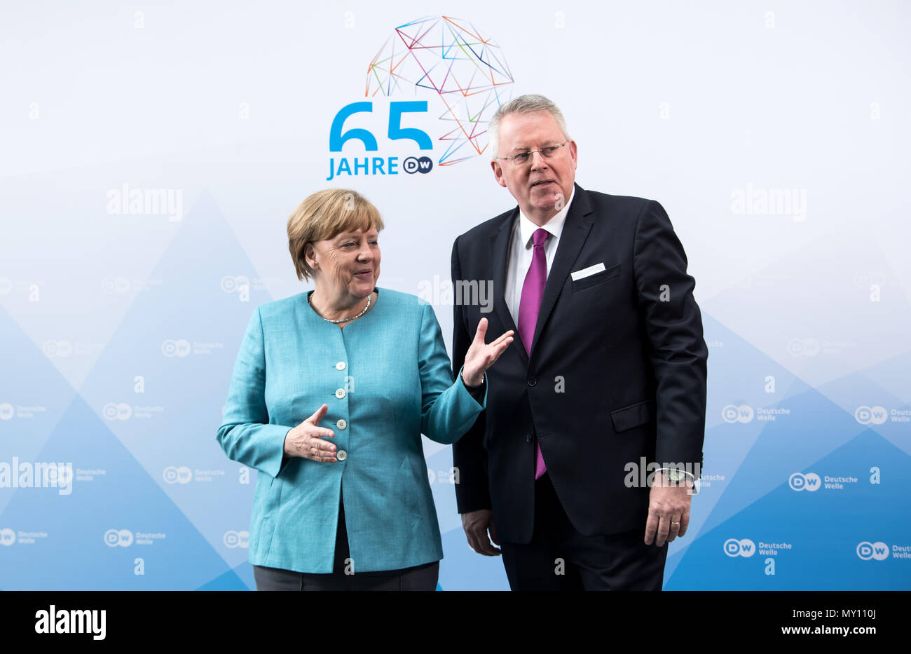 05 June 2018, Germany, Berlin: German Chancellor Angela Merkel of the  Christian Democratic Union (CDU) is welcomed by Peter Limbourg, director of  the Deutsche Welle during the ceremony '65 Jahre Deutsche Welle' (