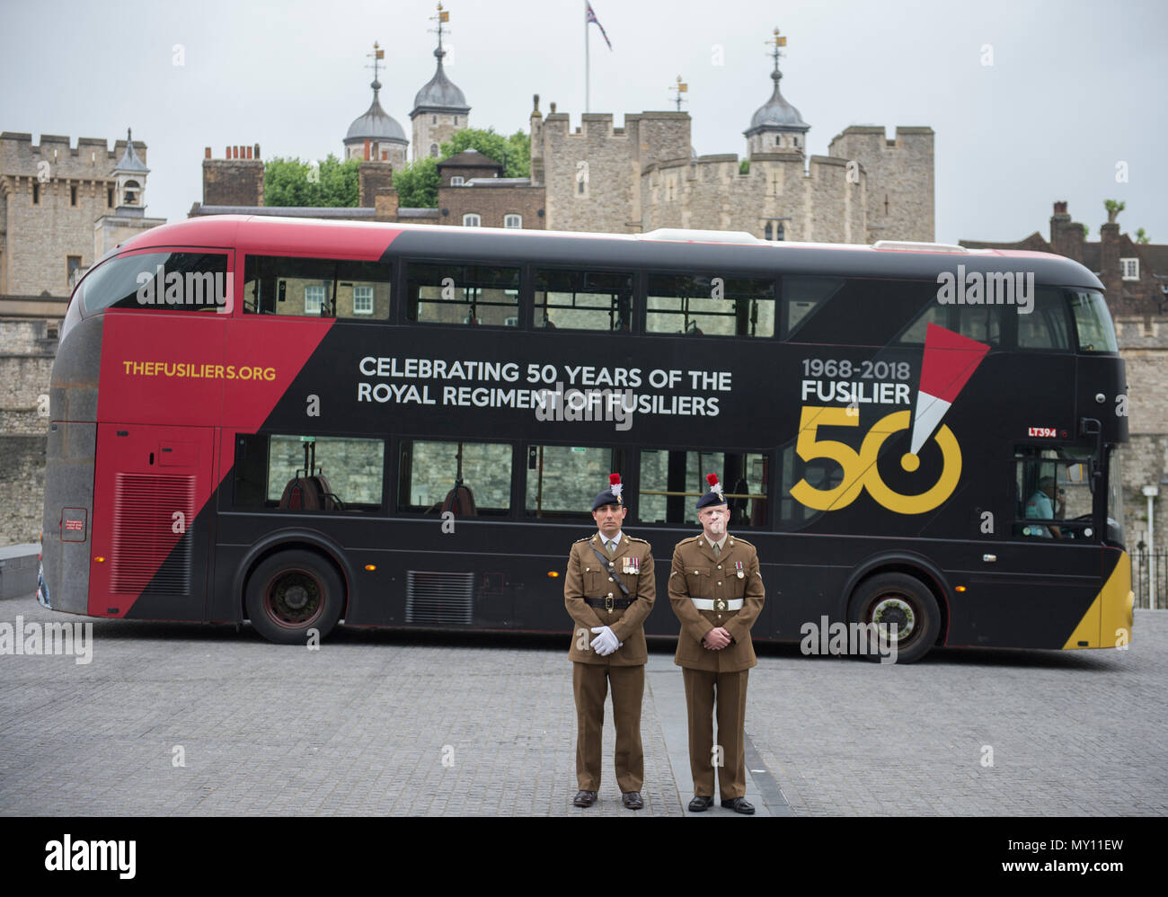 Tower of London, UK. 5 June, 2018. To mark the special occasion of the Royal Regiment of Fusiliers 50th anniversary a new double decker Routemaster bus has been wrapped in the Regimental colours of rose and primrose on a striking black background and features the Fusilier 50 logo. The initiative is a joint partnership between the Royal Regiment of Fusiliers, Go-Ahead London, Exterion Media and Historic Royal Palaces, an independent charity who look after The Tower of London. Credit: Malcolm Park editorial/Alamy Live News Stock Photo