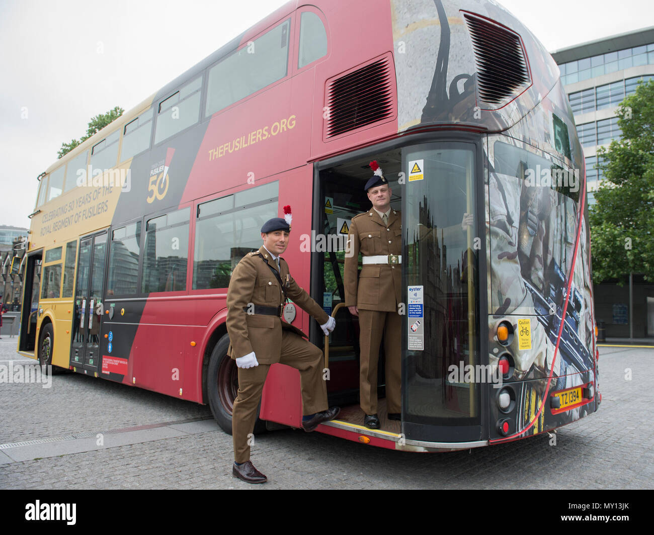 Tower of London, UK. 5 June, 2018. To mark the special occasion of  the Royal Regiment of Fusiliers 50th anniversary a new double decker Routemaster bus has been wrapped in the Regimental colours of rose and primrose on a striking black background and features the Fusilier 50 logo. The initiative is a joint partnership between the Royal Regiment of Fusiliers, Go-Ahead London, Exterion Media and Historic Royal Palaces, an independent charity who look after The Tower of London. Credit: Malcolm Park editorial/Alamy Live News Stock Photo