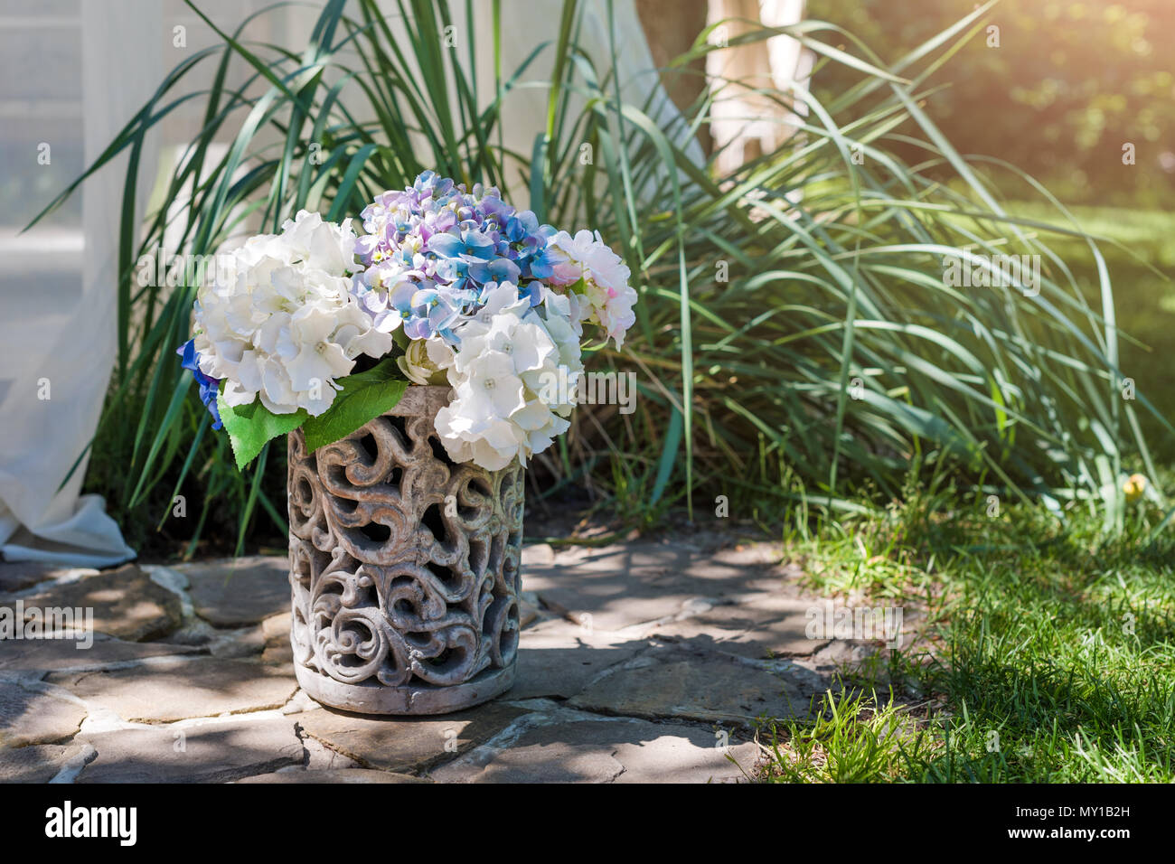 Fresh Flowers Arrangement In Vase In The Garden Decorative