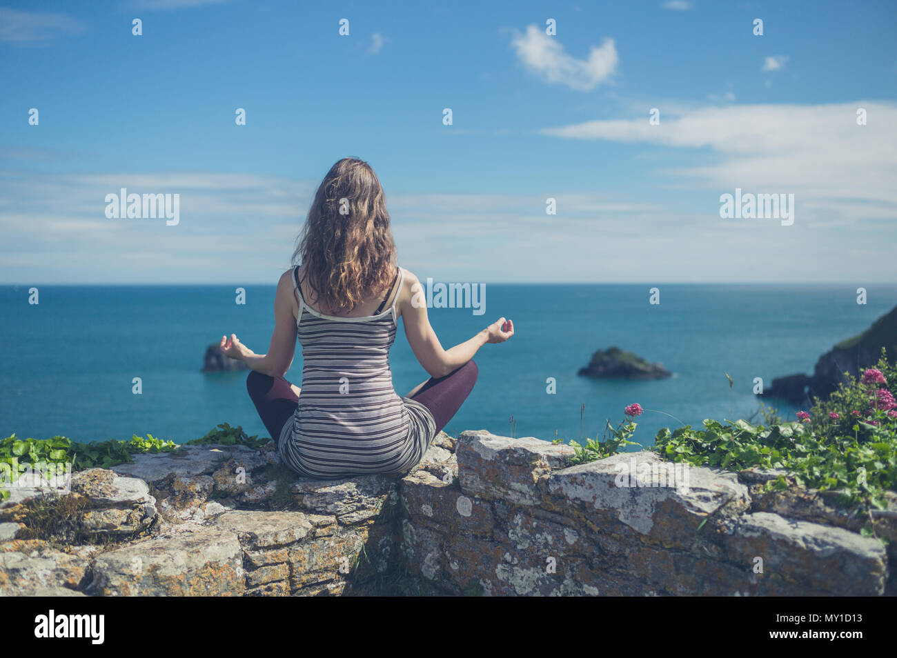 Woman sitting on wall sea hi-res stock photography and images - Alamy