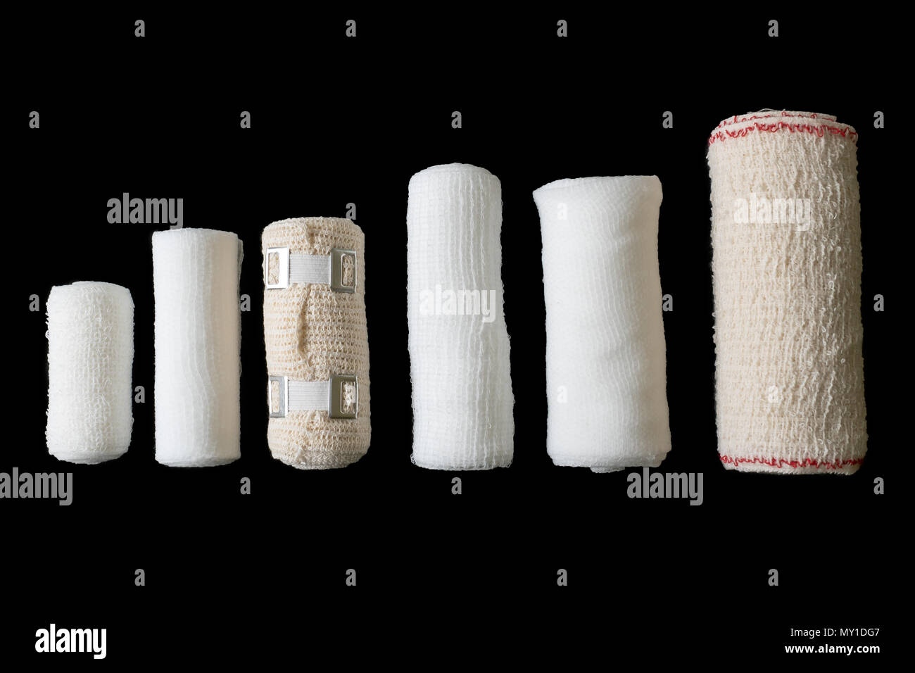 Different sizes of medical bandages. Medical bandages isolated on black
