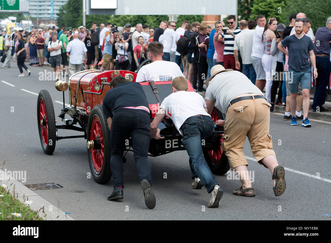 Men pushing a vintage car Stock Photo