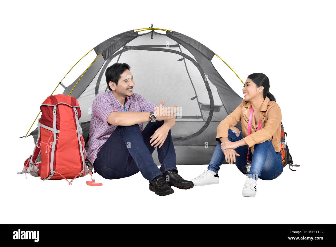 Portrait of asian couple discussion in front of tent isolated over white background Stock Photo