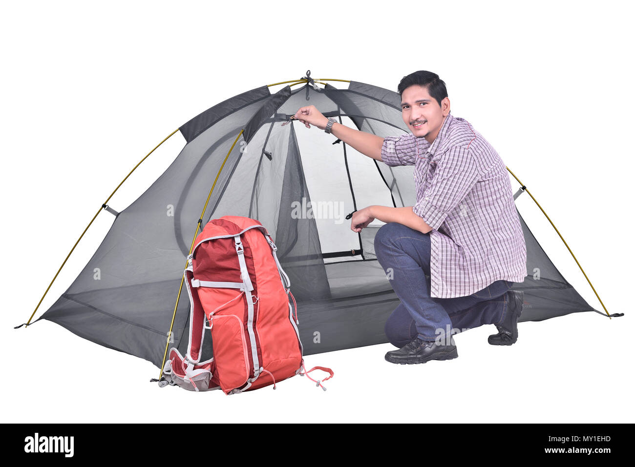 Portrait of asian backpacker man prepare the tent posing isolated over white background Stock Photo