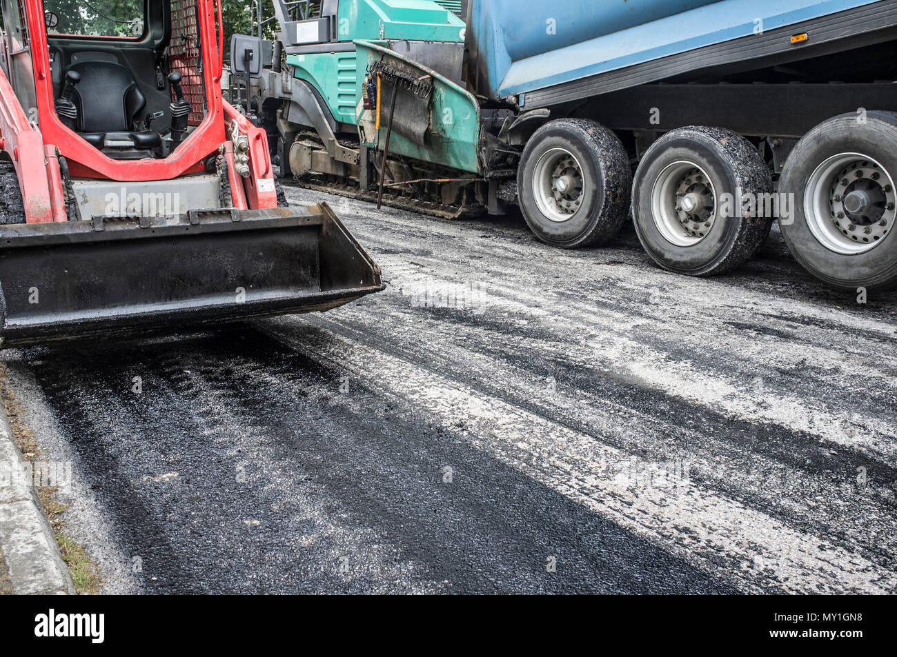 Work on the laying of asphalt in the city. Lifting hook bucket, dump ...