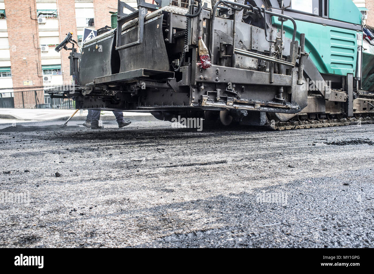 Work on the laying of asphalt in the city. Paving applicator machine or paver at work Stock Photo