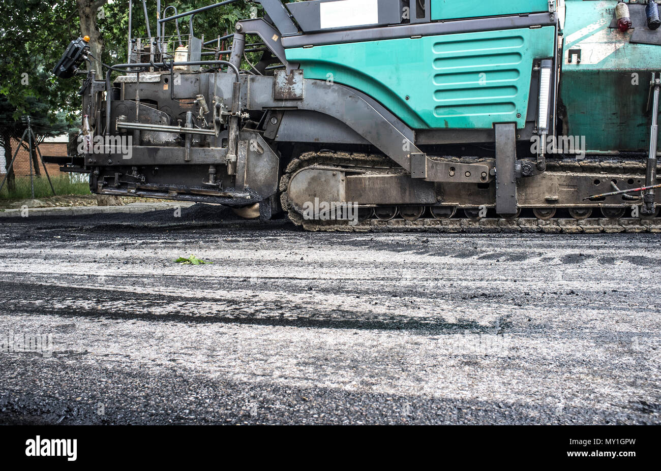 Work on the laying of asphalt in the city. Paving applicator machine or paver at work Stock Photo