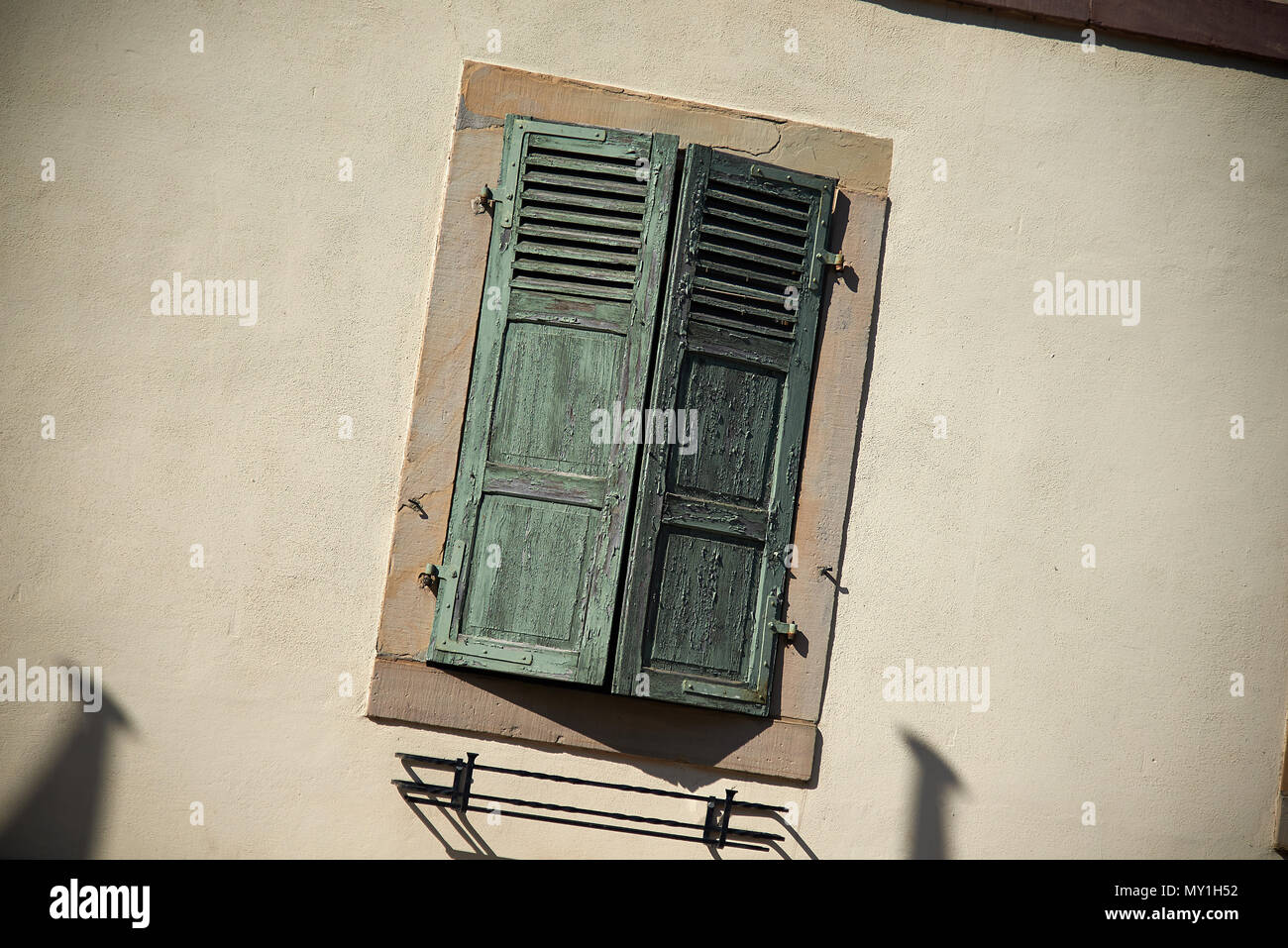 Typical wooden window shutters and architecture of houses and farms in