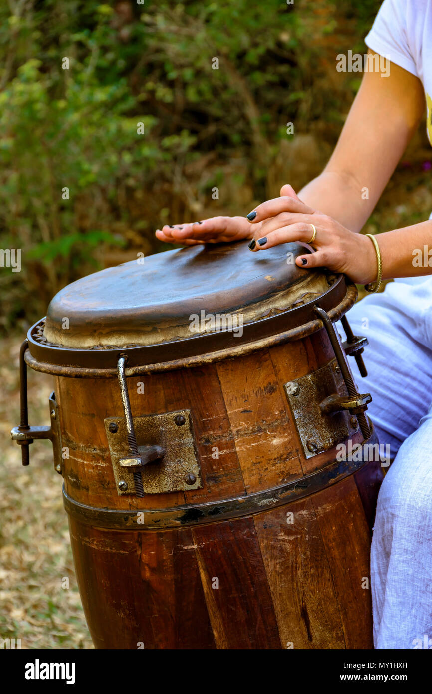 Woman percussionist hands playing a drum called atabaque during brazilian folk music performance Stock Photo