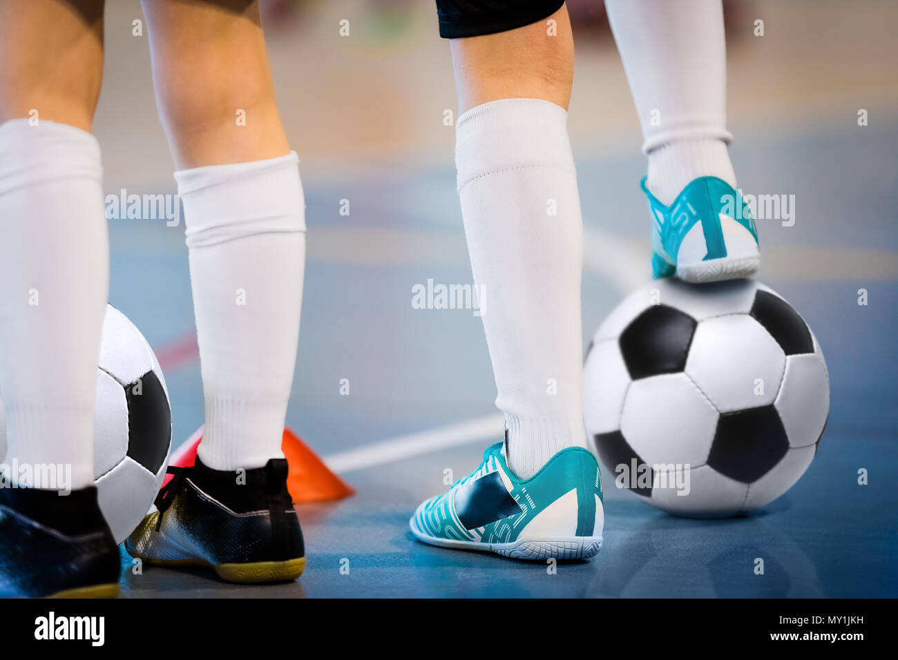 Indoor soccer players training with balls. Indoor soccer sports hall