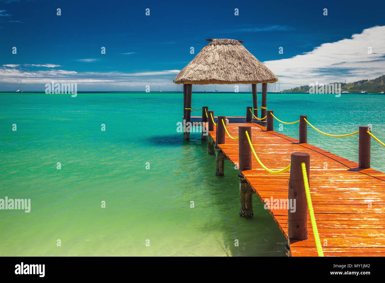 Red wooden jetty extending to tropical ocean on Fiji Island Stock Photo ...