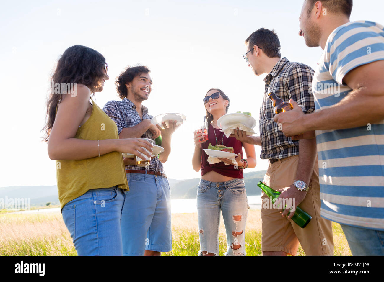 Young men and women on BBQ party in country Stock Photo