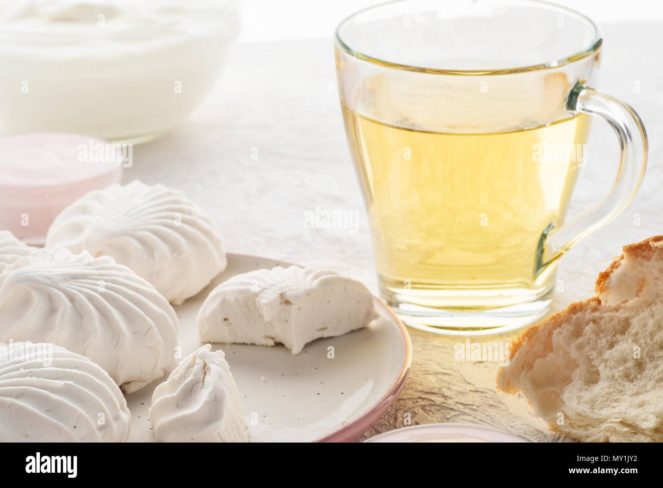 Protein products ingredients for breakfast marshmallows sour cream yogurt milk piece of bread green tea Stock Photo