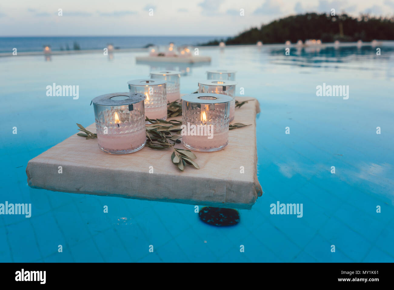 Candles floating in swimming pool at beach house party Stock Photo Alamy